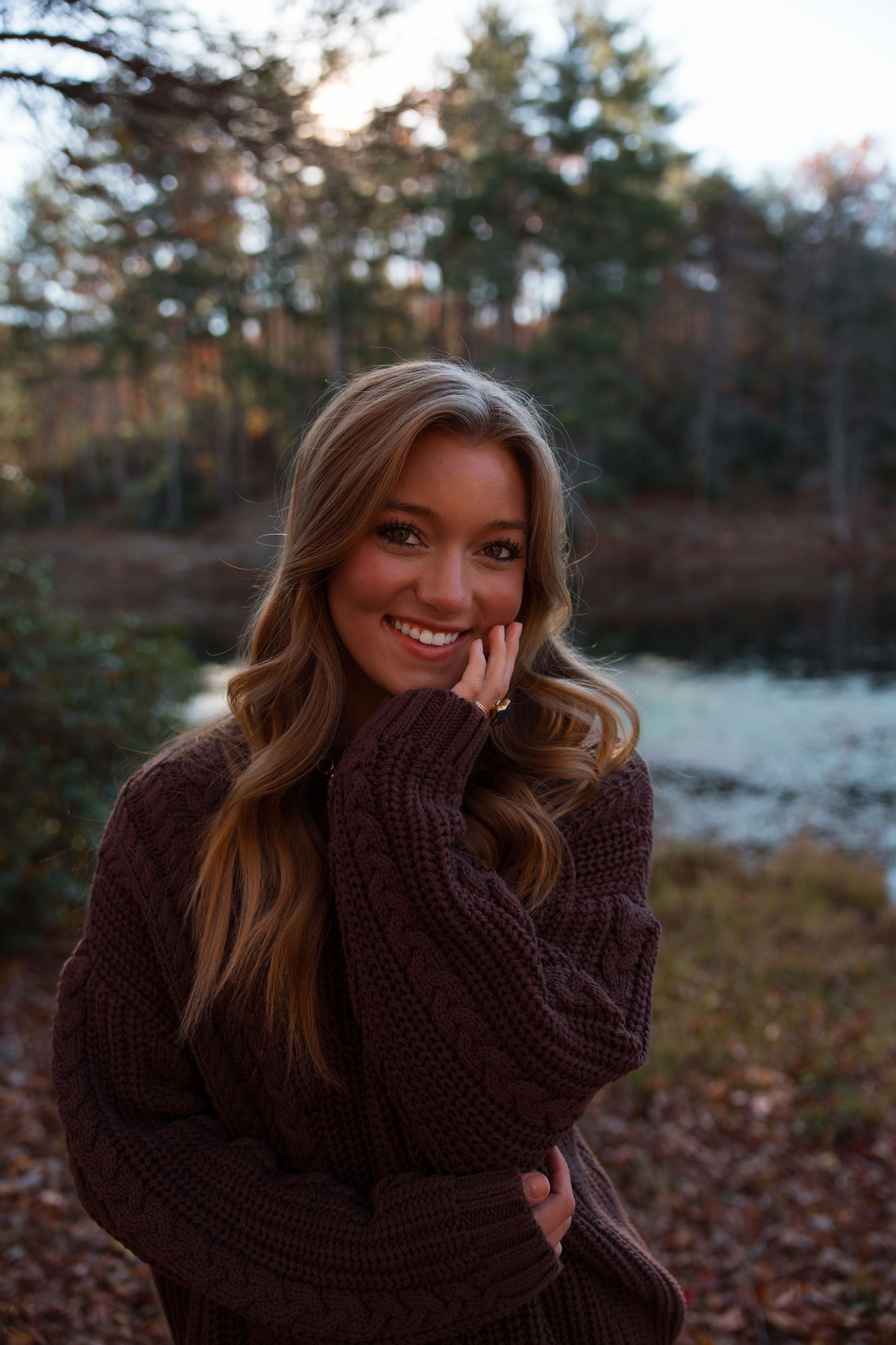 Candid portraits in cozy sweater with natural autumn scenery.