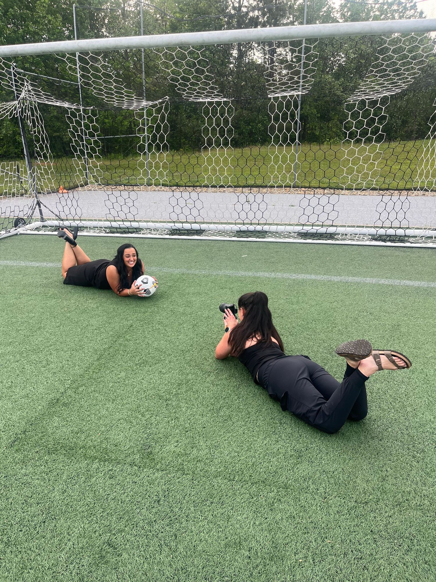 A series of photos showing a person lying on artificial turf demonstrating different soccer goalie save positions.