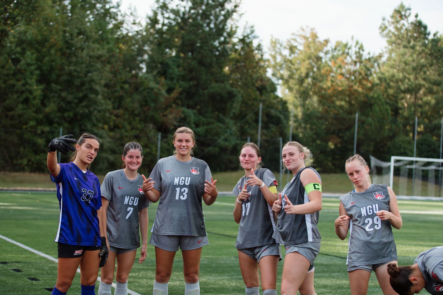 Soccer team members gather for a group picture during half time.