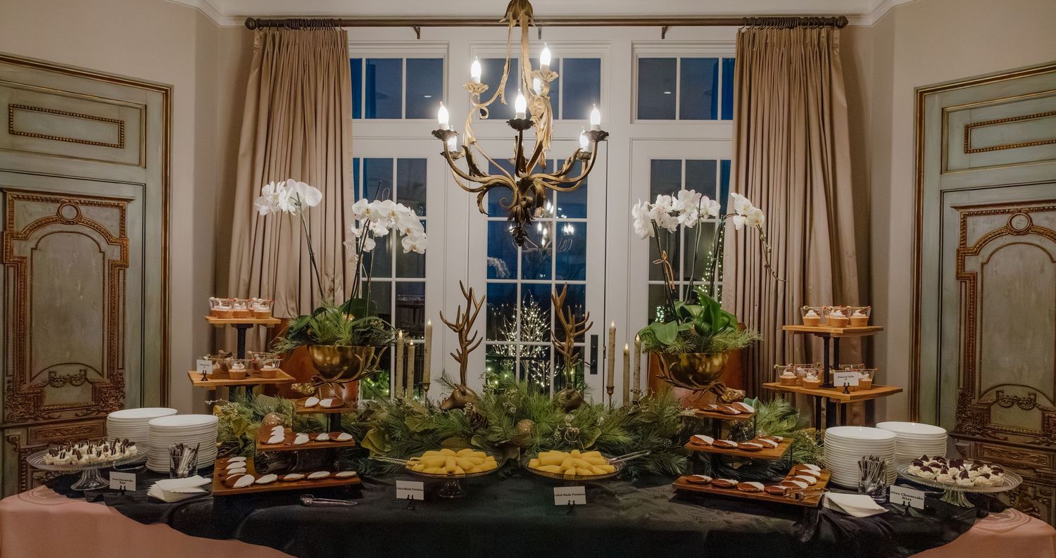 Elegant dining room with crystal chandelier and ornate gold decor for upscale event.