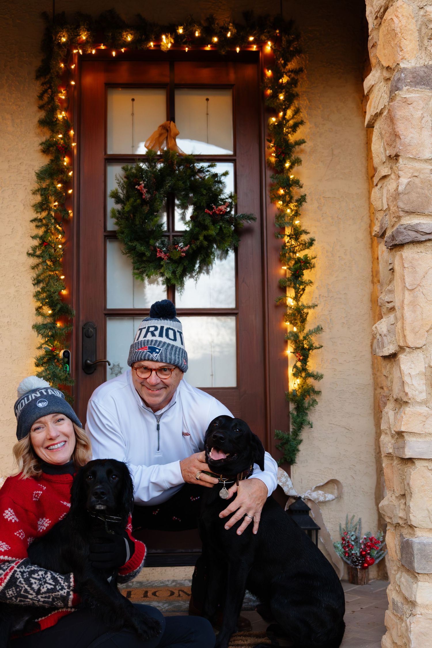 Candid moment on a holiday-decorated porch with twinkling lights.