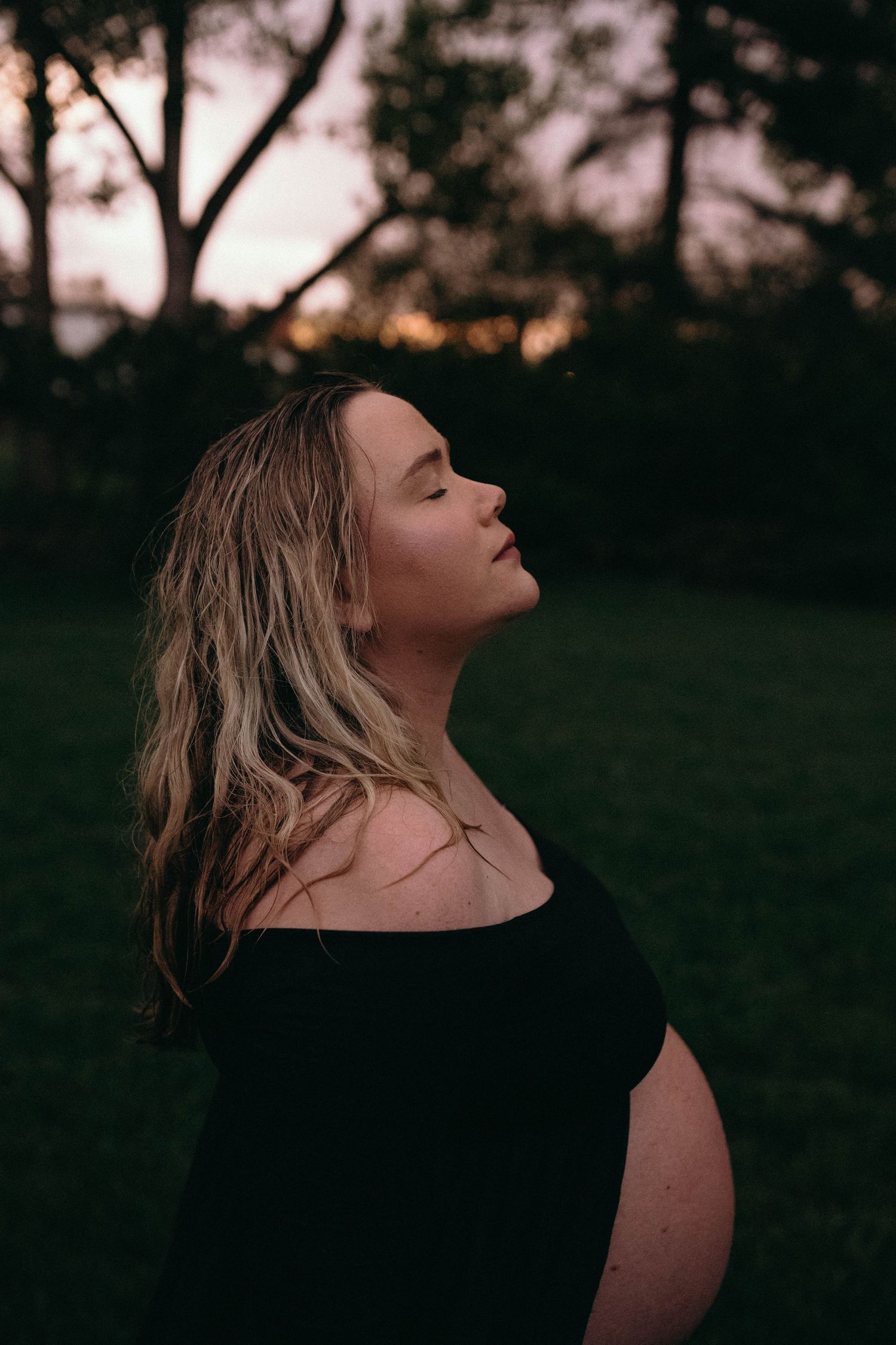 Artistic portrait captured during golden hour with atmospheric lighting.
