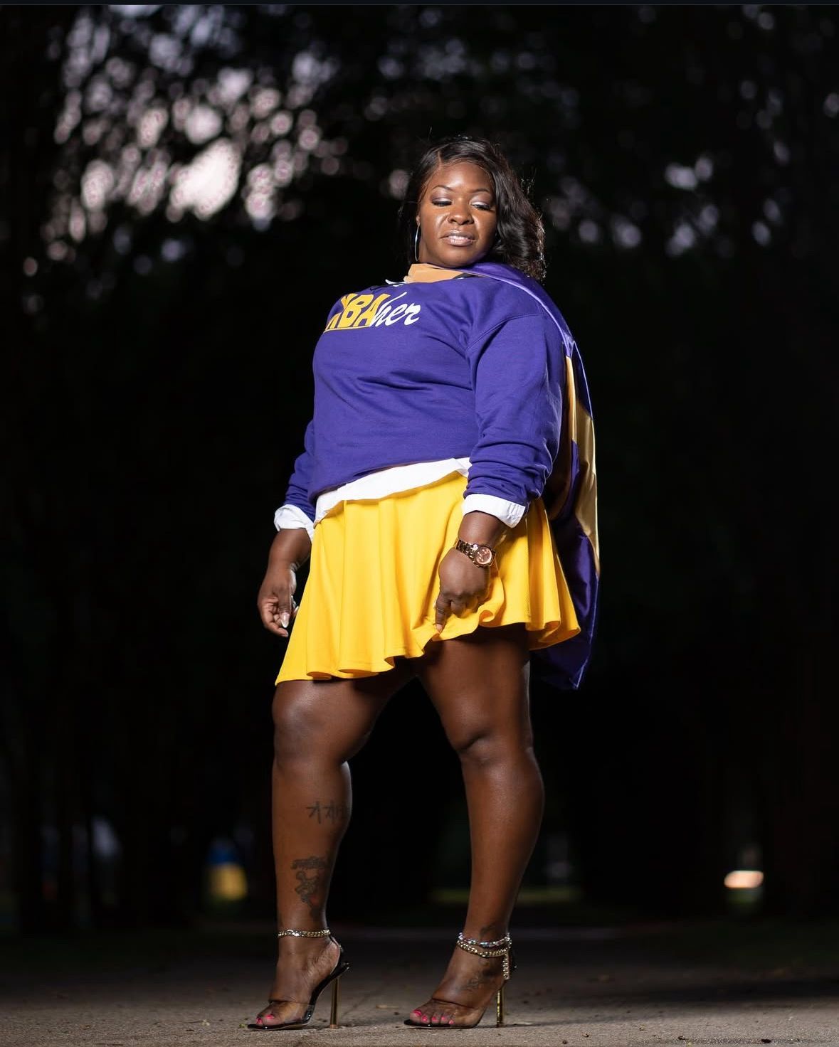 College graduate posing with cap and gown in downtown Austin, TX.