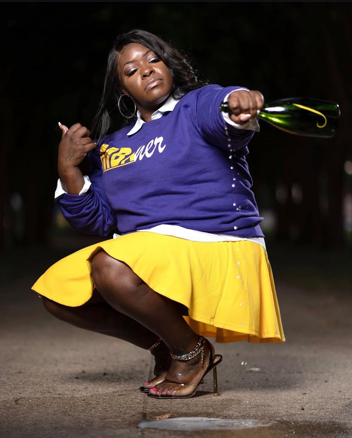 College graduate pouring her celebration champagne in downtown Austin, Tx.
