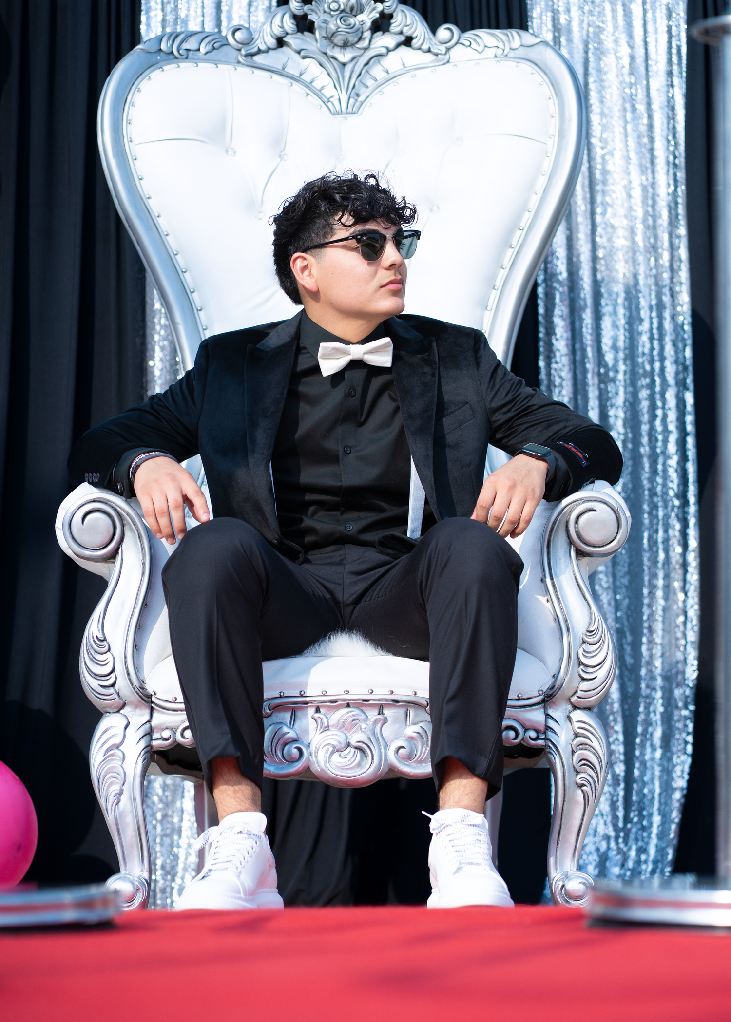 Individual prom photo posed on a king chair in North Austin.