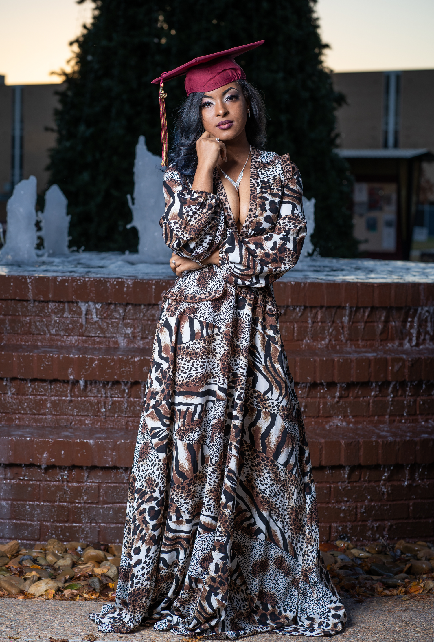 College graduate posing with cap and gown in downtown Austin, TX.