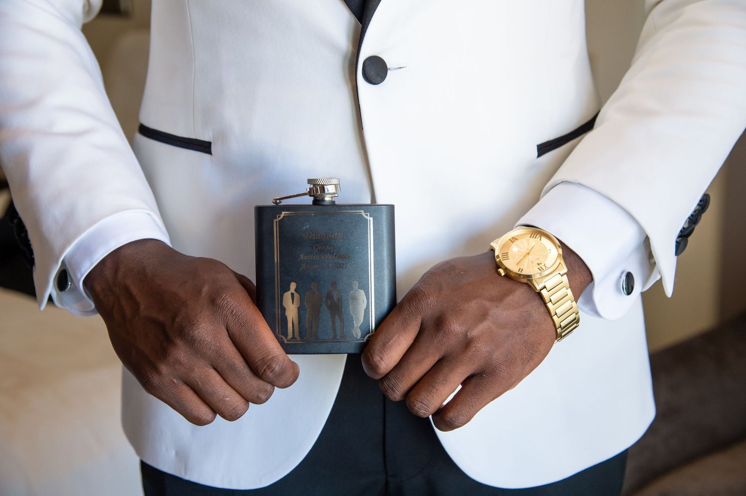 Close-up details of business professional attire showing crisp white dress shirt with cufflinks and gold watch.