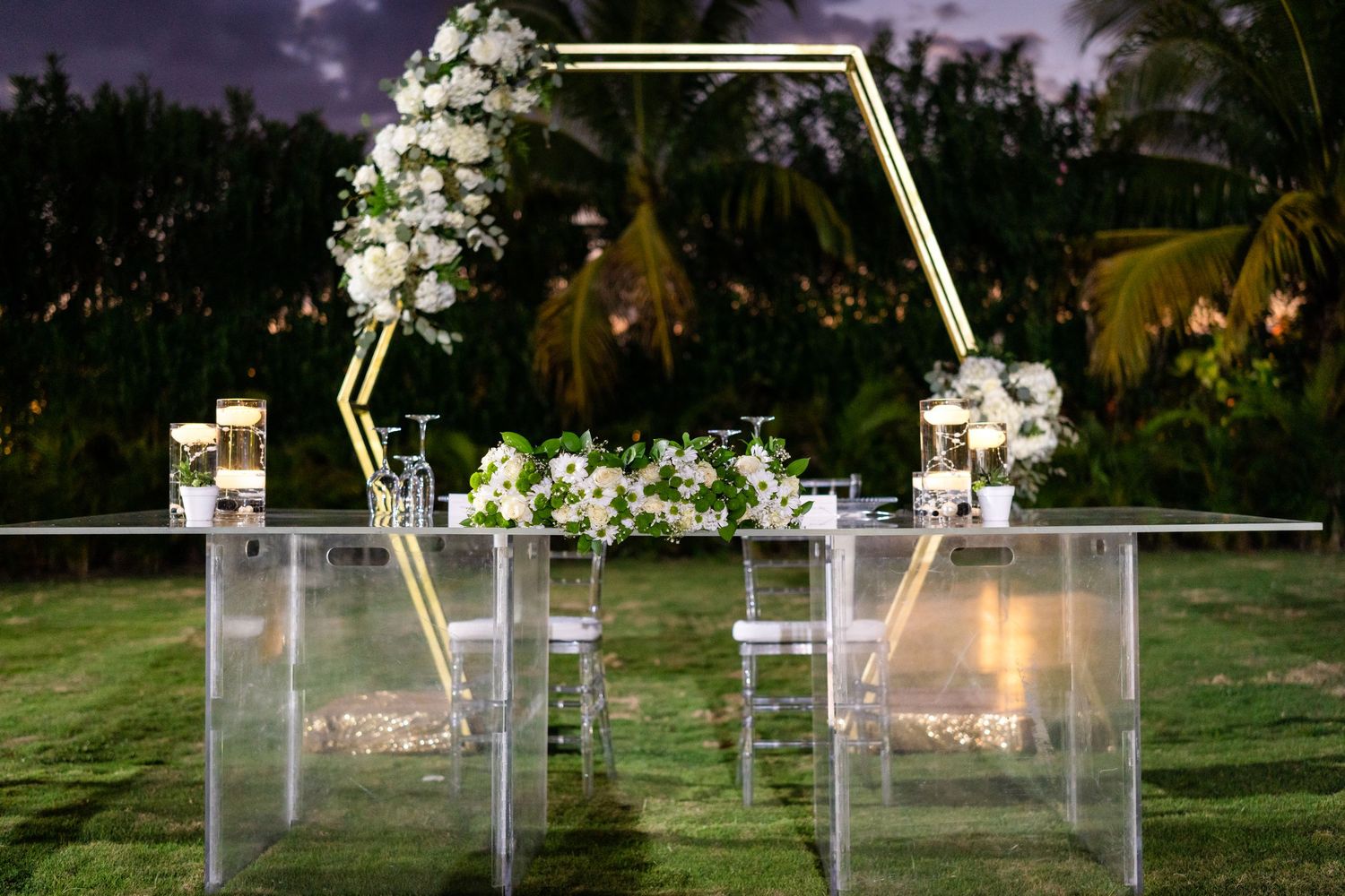 Illuminated acrylic wedding signs and decorative elements creating an ethereal nighttime garden display.