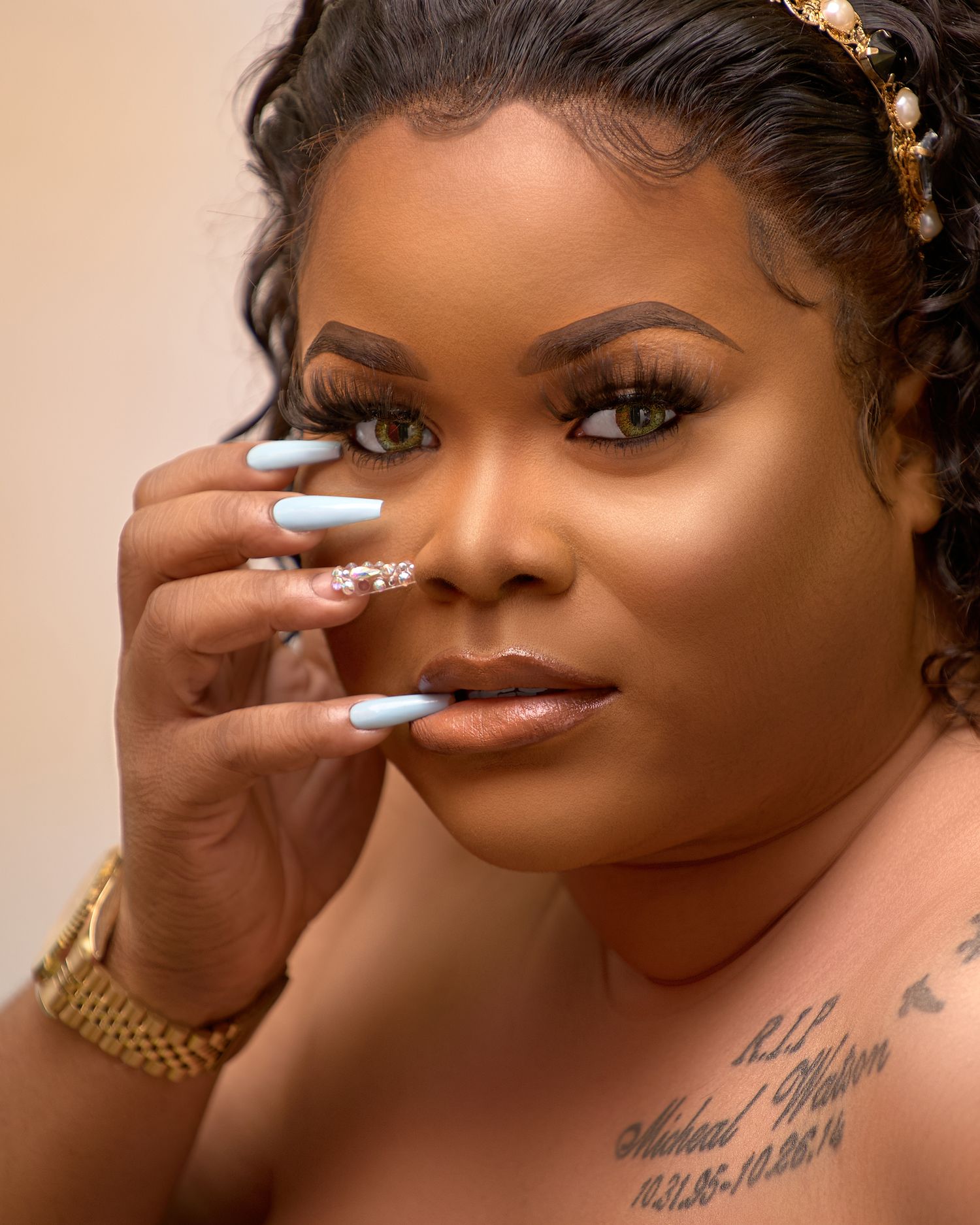 Artistic beauty portrait of a young lady with dramatic lighting showing close up lip poses with fingers touching face.