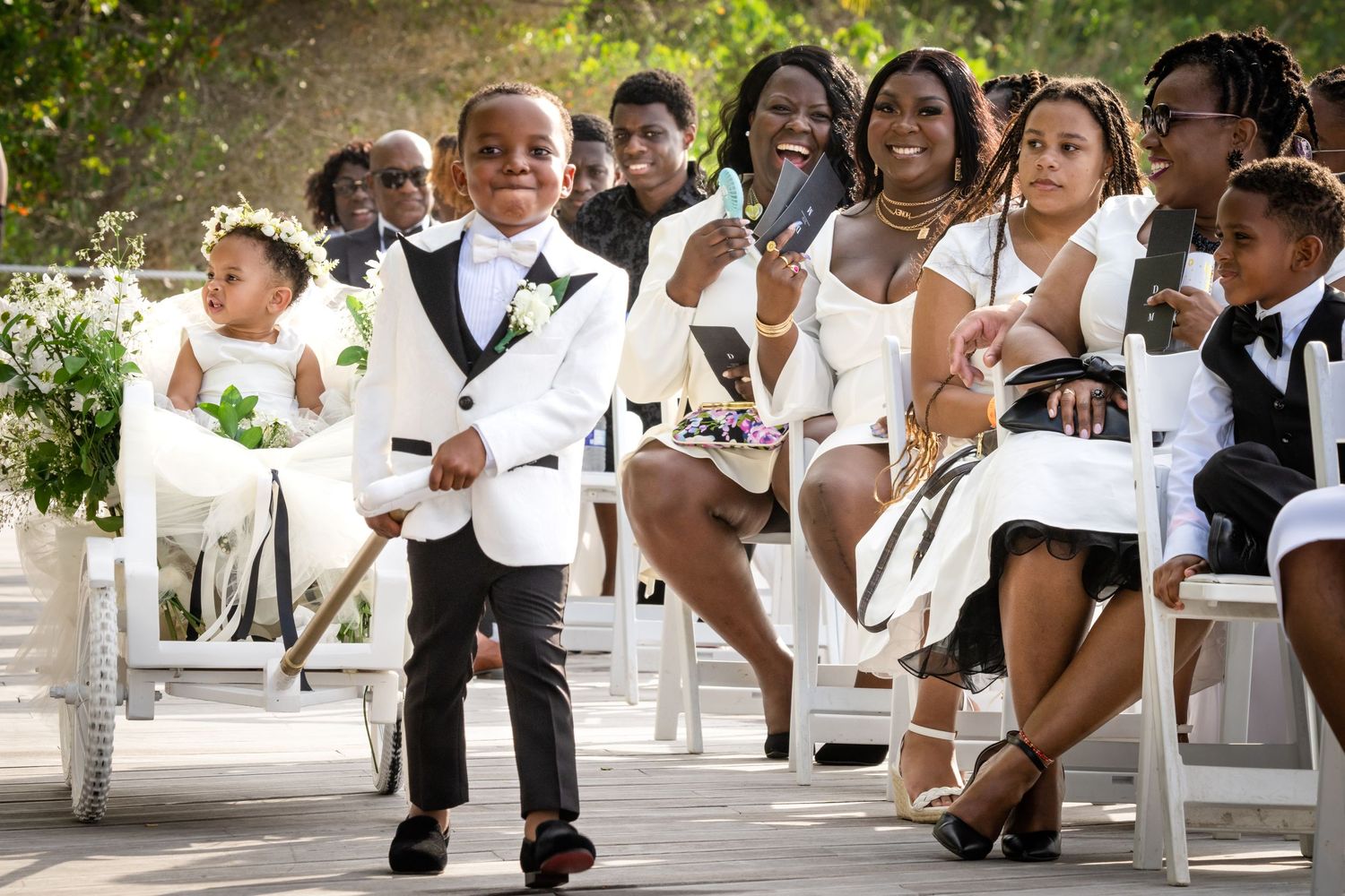 Wedding guests smile and dance together on the dance floor during a joyous celebration at a reception venue.