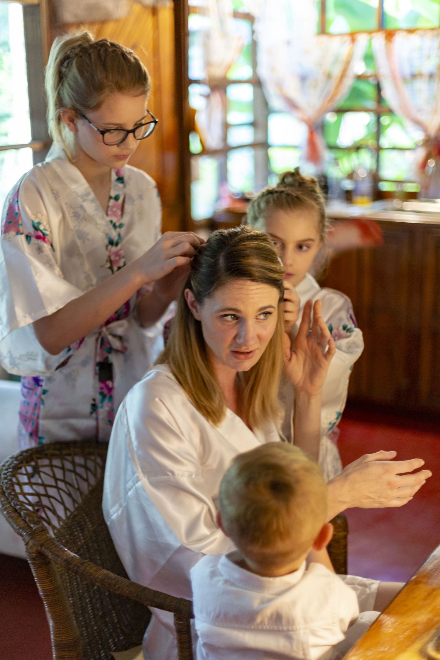 People in white robes react with excitement and surprise during what appears to be an engaging indoor gathering.