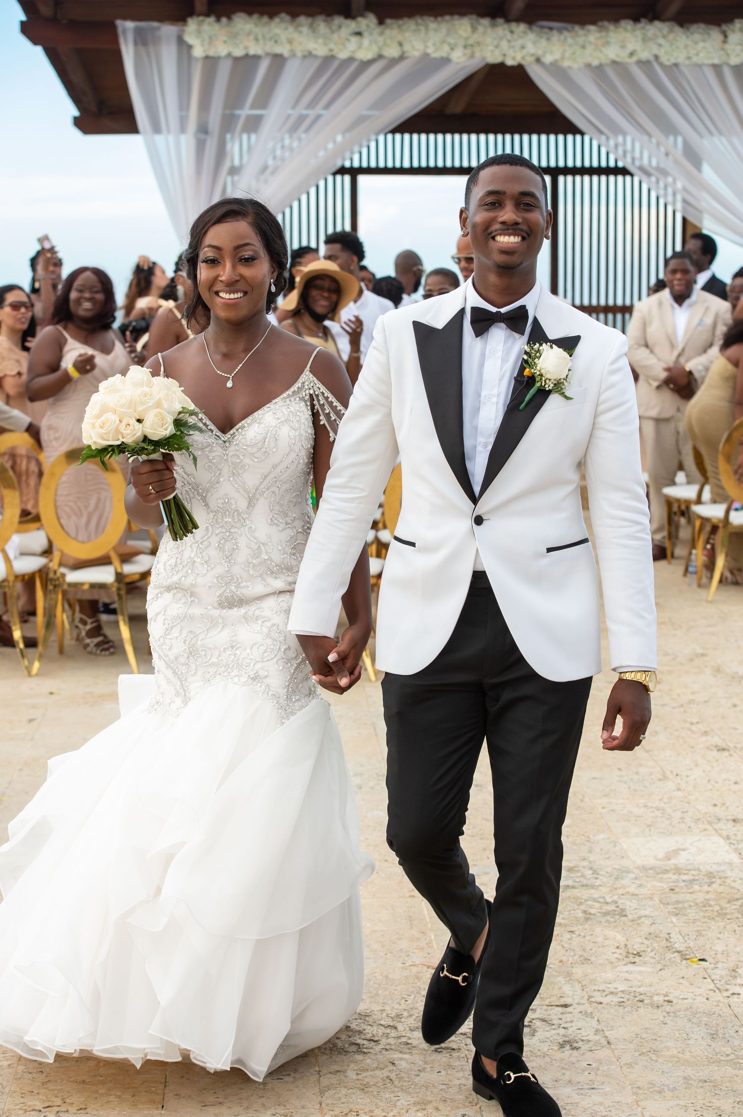 Three beach wedding photos showing joyful moments with couples in formal white attire.