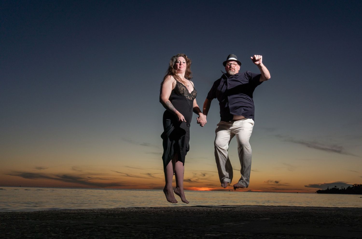 A series of sunset silhouettes show couples getting engaged on a beach with beautiful orange sky backgrounds.
