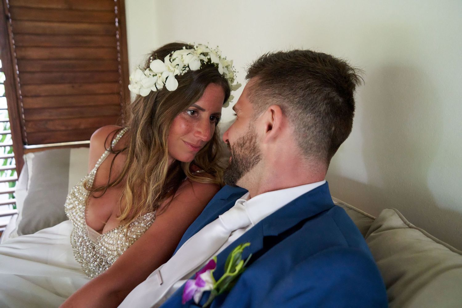 Four professional quality photos show a couple sharing intimate moments in a vintage inspired wedding setting with classic decor.