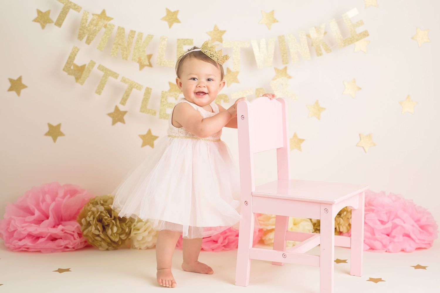 Pink tulle and gold stars create a magical first birthday cake smash photo session setup. San Diego cake smash photographer