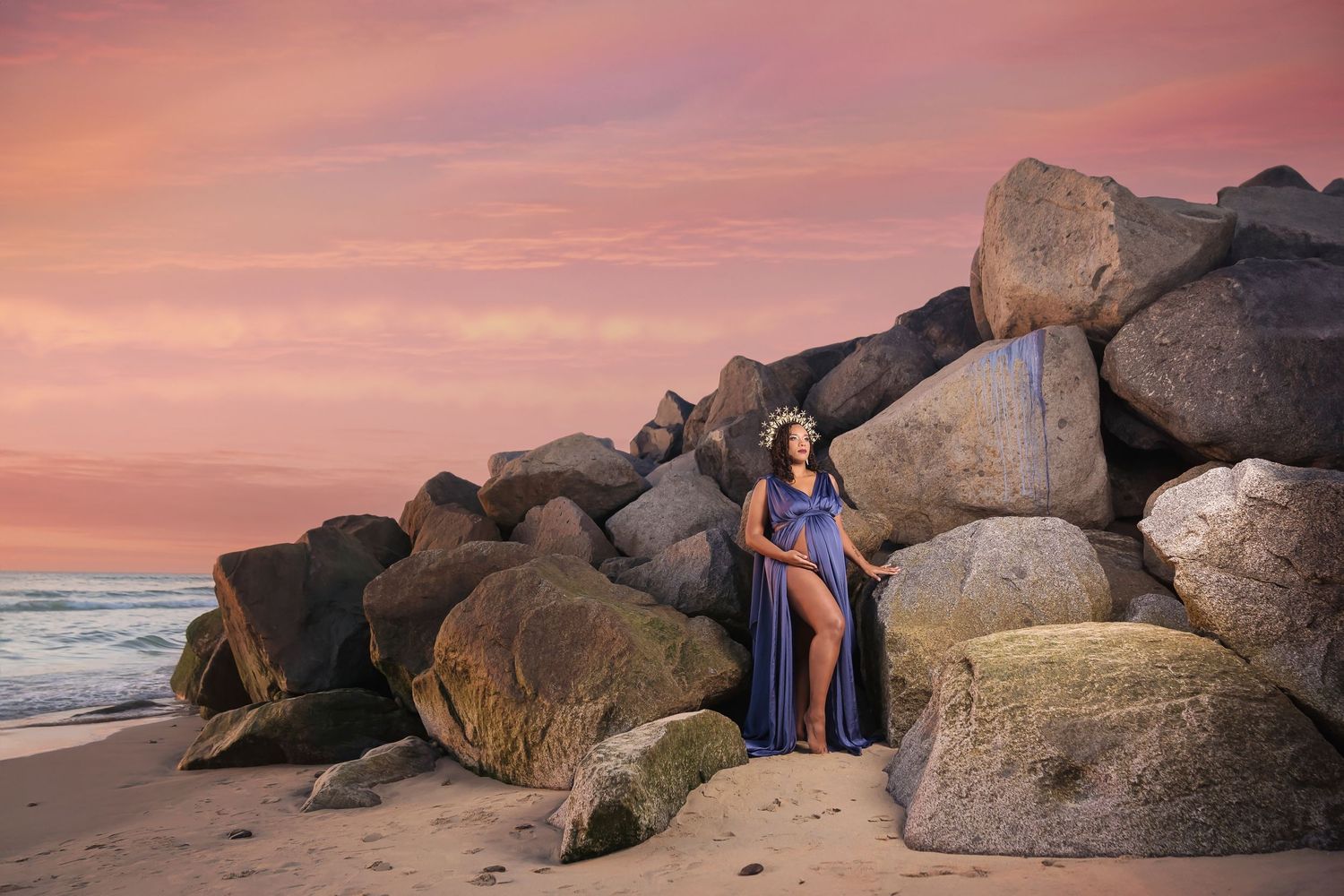 Artistic beach maternity portraits with subjects among rocky formations at dusk. San Diego Maternity Photographer