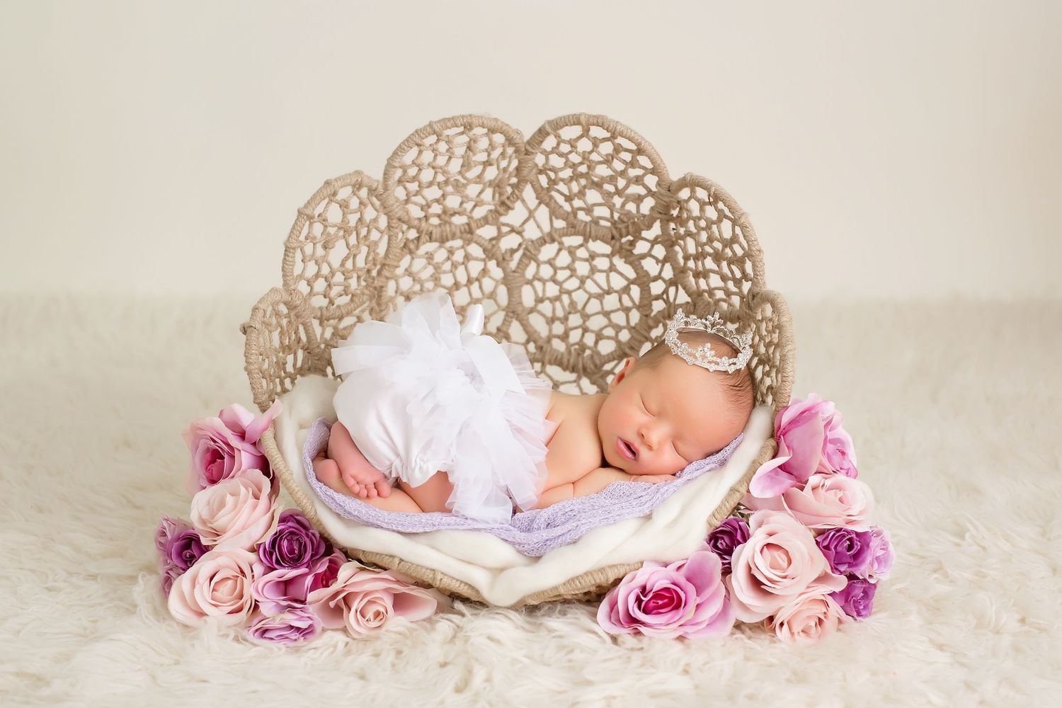 Elegant newborn setup with lace props and pink roses. San Diego Newborn Photographer