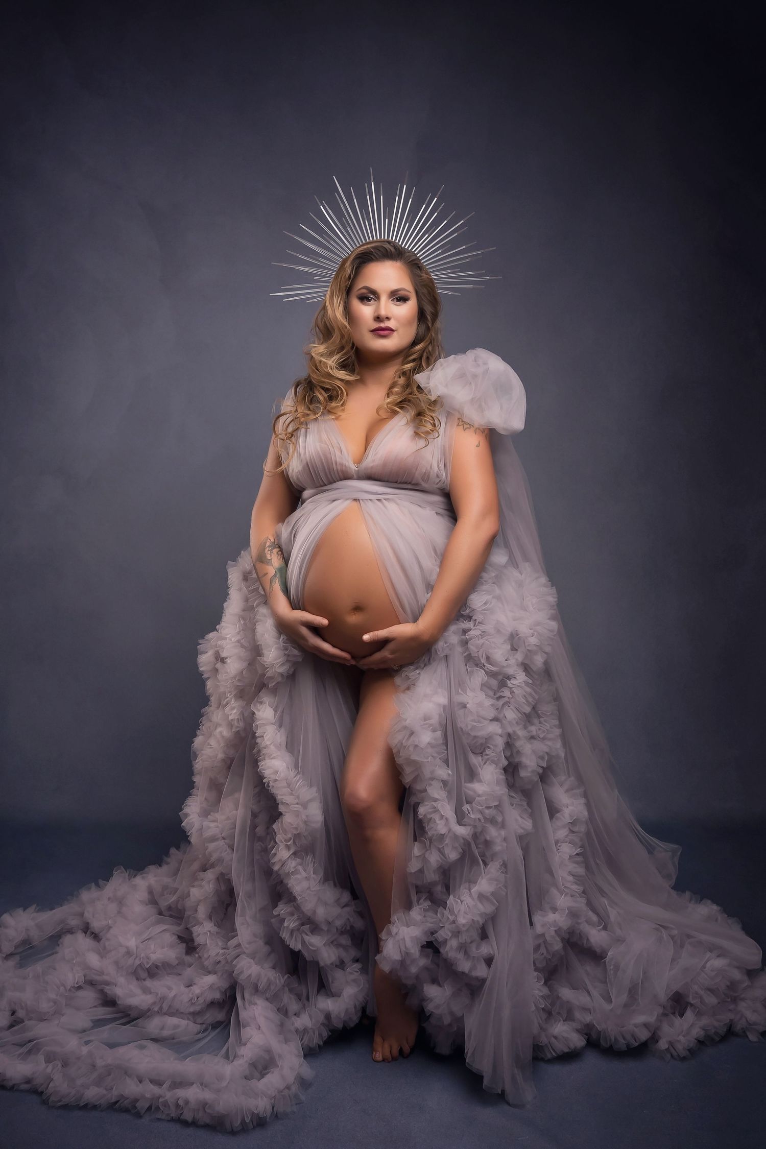 Ethereal maternity portrait with silver crown and flowing grey gown