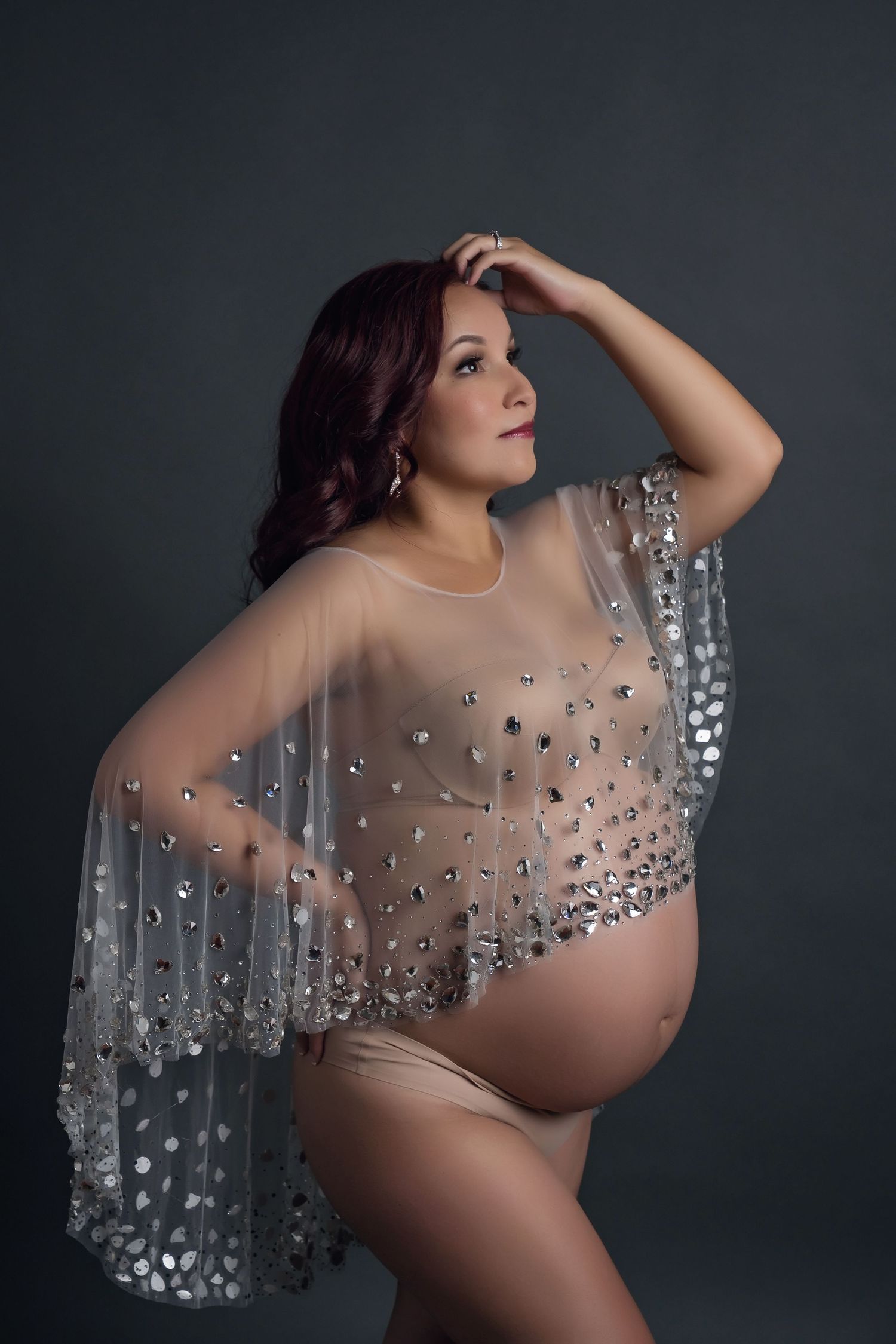 Artistic maternity boudoir photography series of model wearing sheer draped fabric with crystal embellishments in san diego