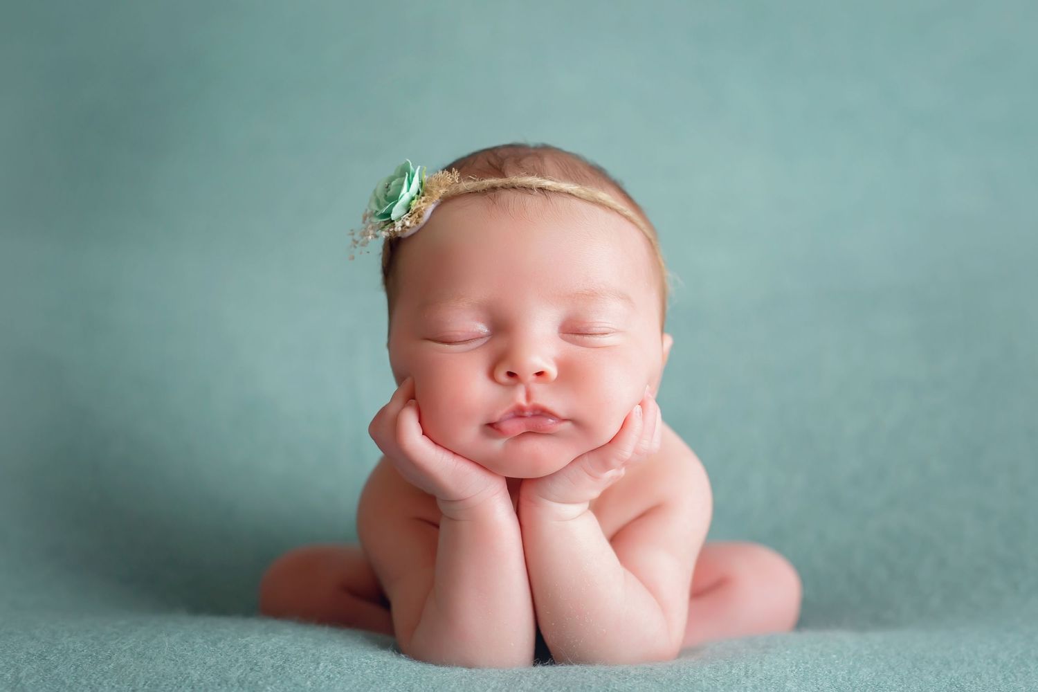 Newborn photography against teal backdrop with minimalist styling. San Diego Newborn Photographer