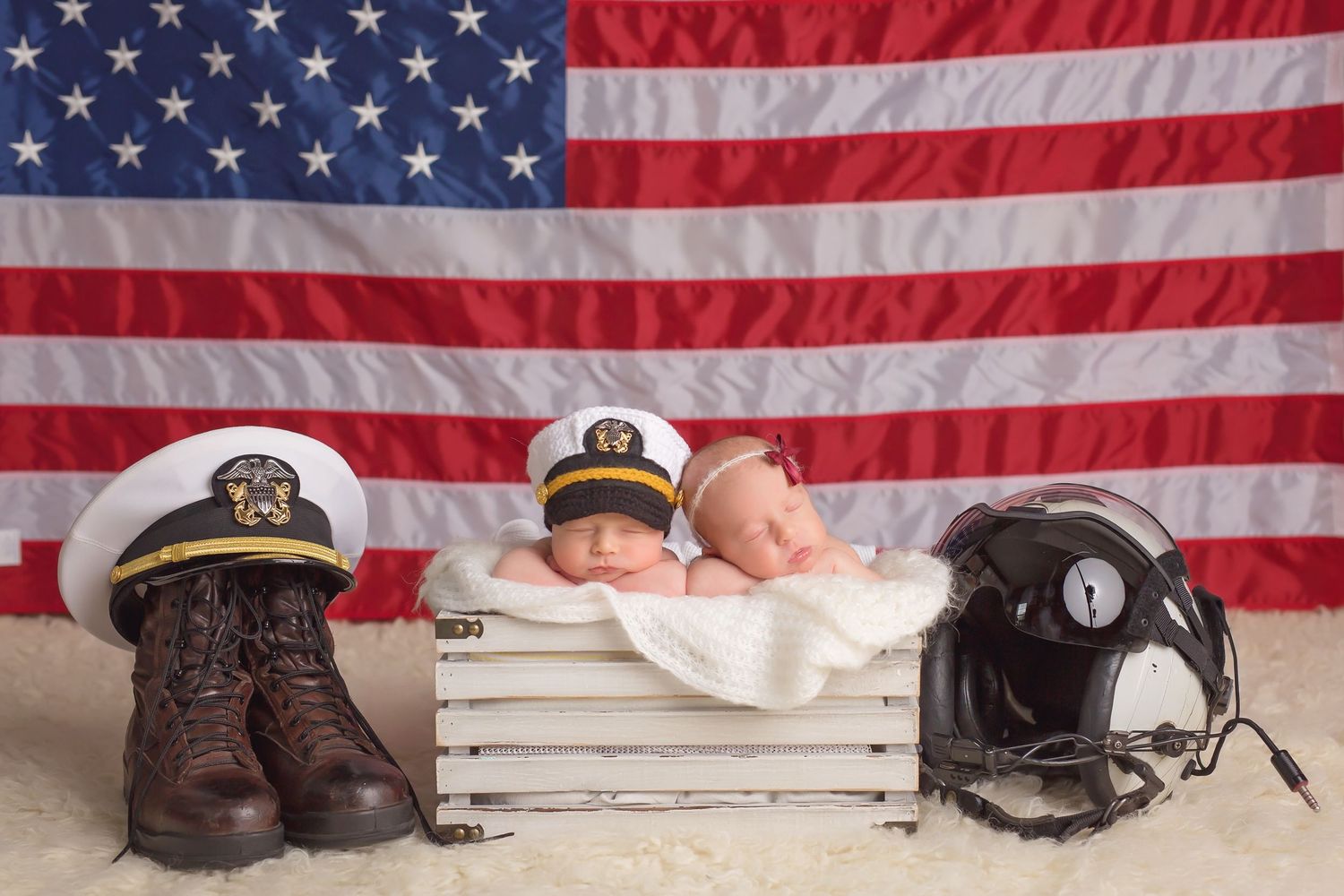 Military themed newborn photo with boots, hat and American flag background. San Diego Newborn Photographer