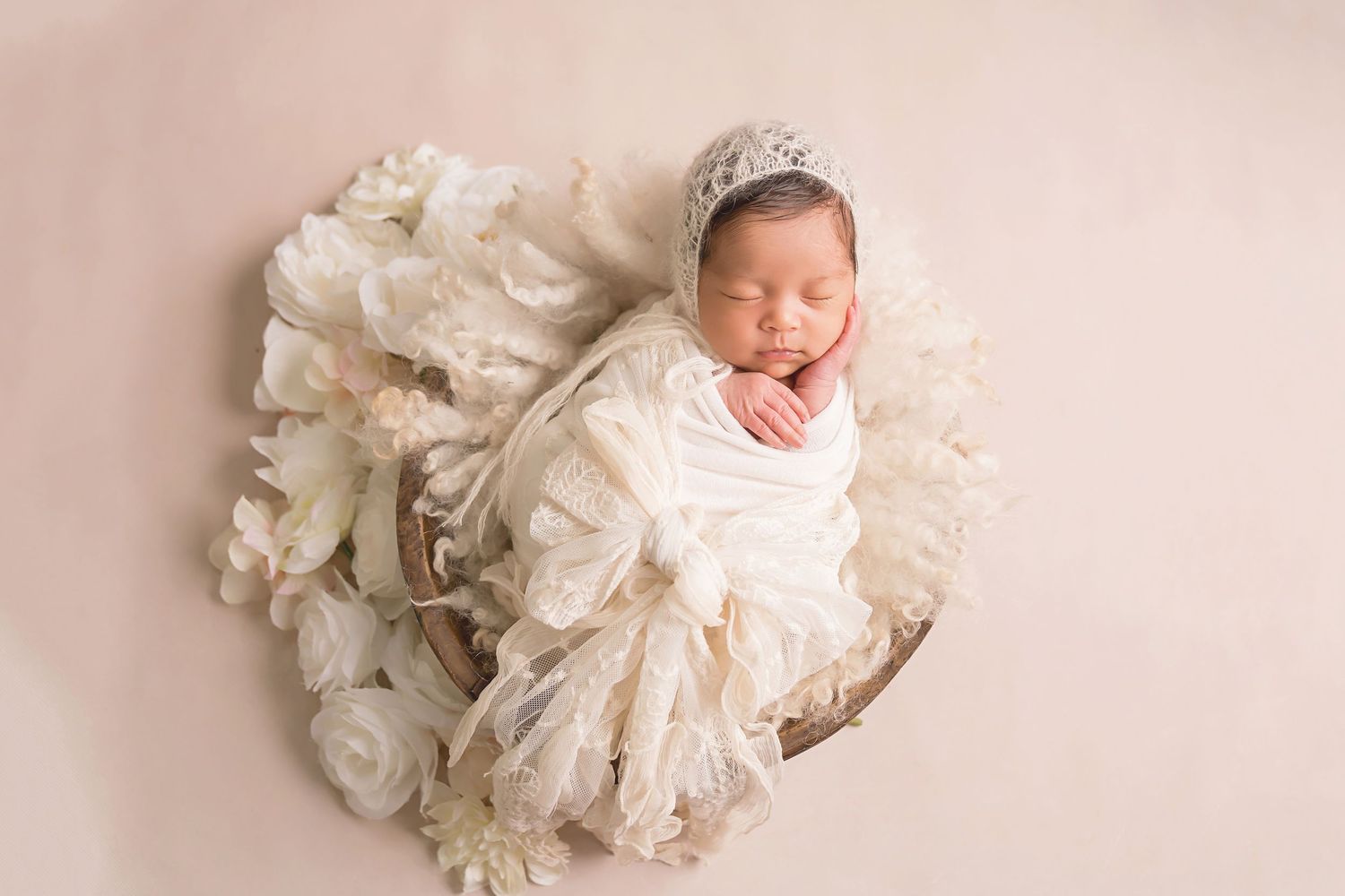 Delicate newborn photography setup with cream lace and soft natural lighting in San Diego Photography studio..