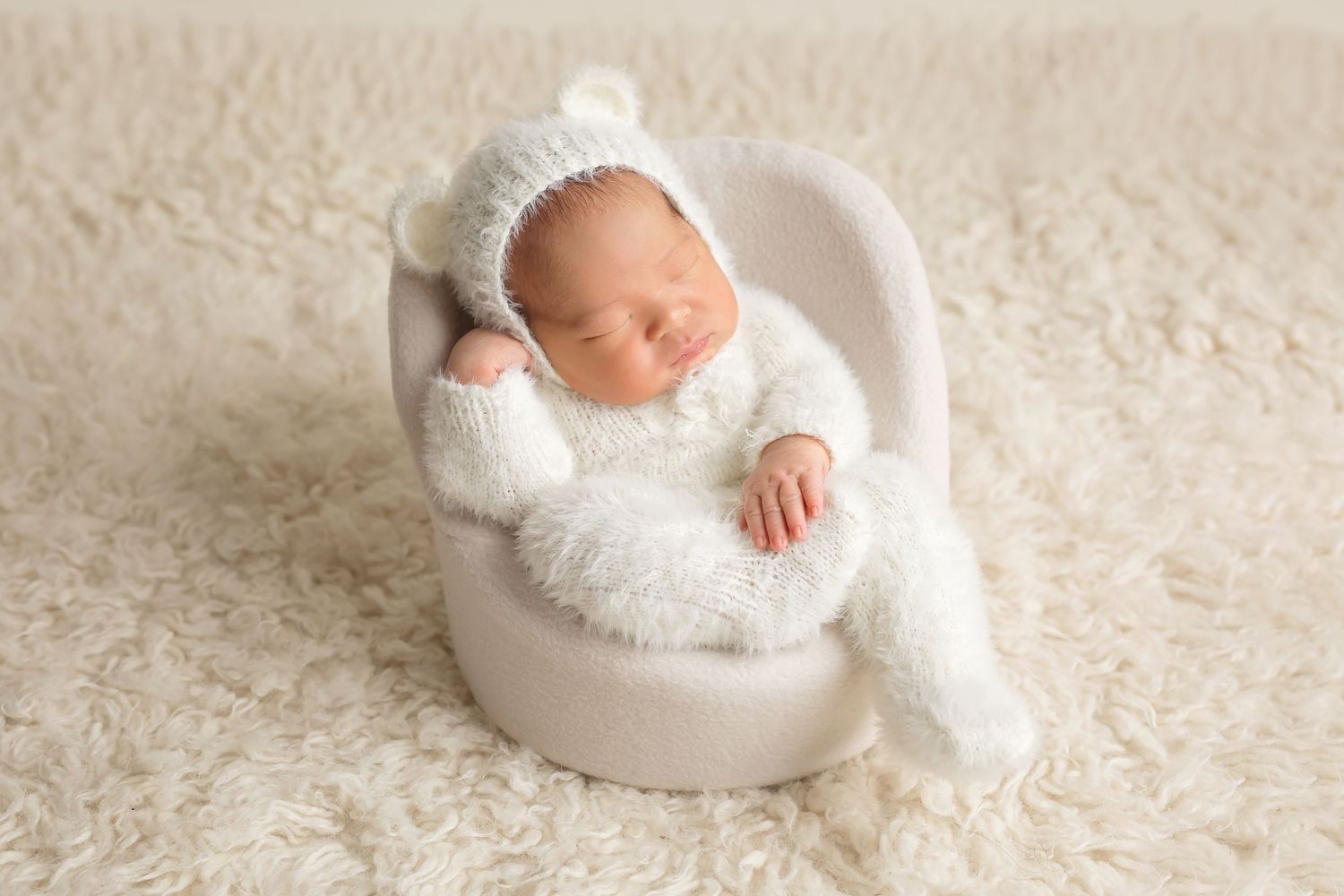 Collection of newborn portraits with baby sleeping on cream textured backdrop. San Diego Newborn Photographer