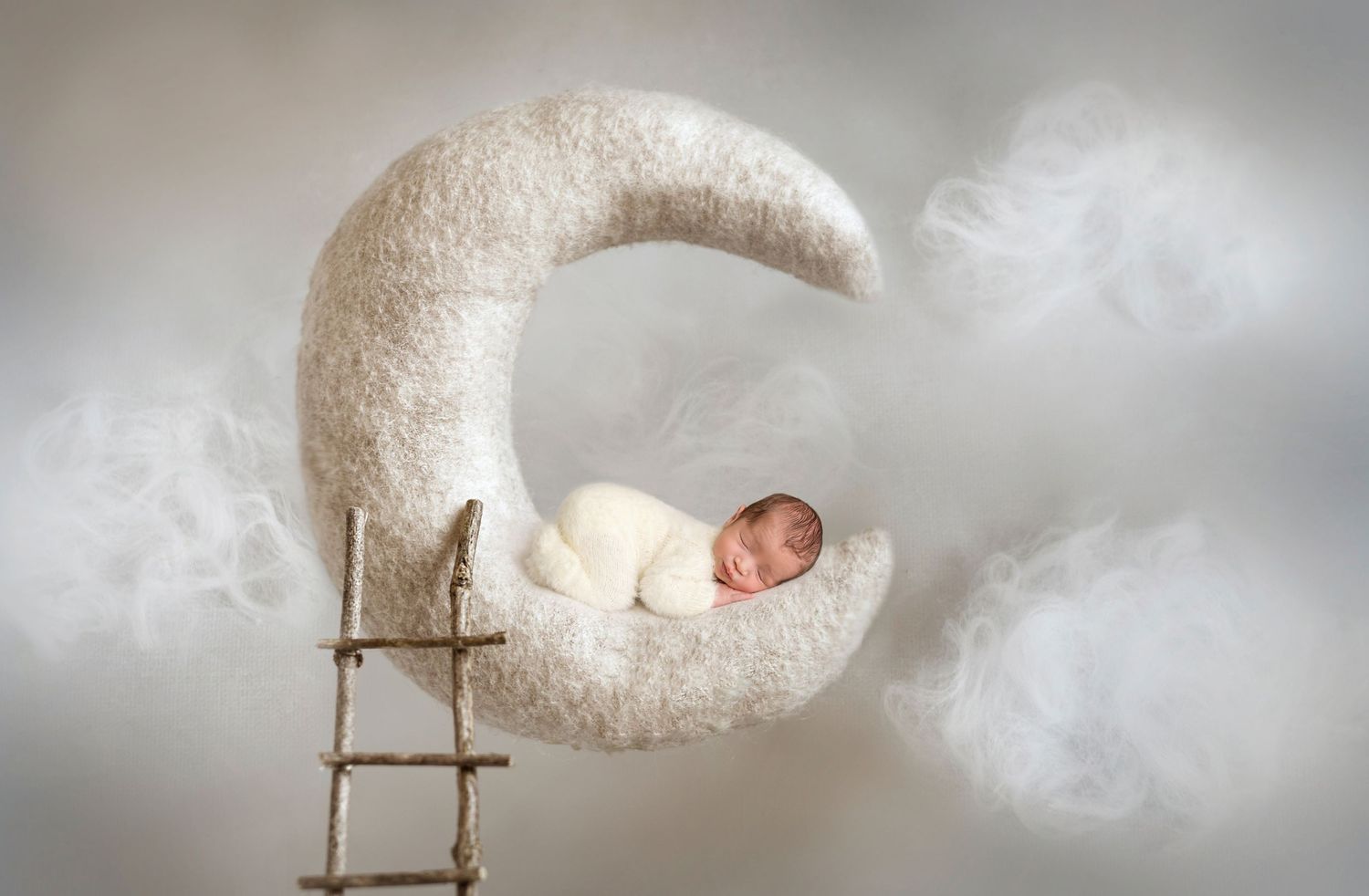 San Diego newborn photographer captures Dreamy newborn photography setup with white moon prop on neutral background.