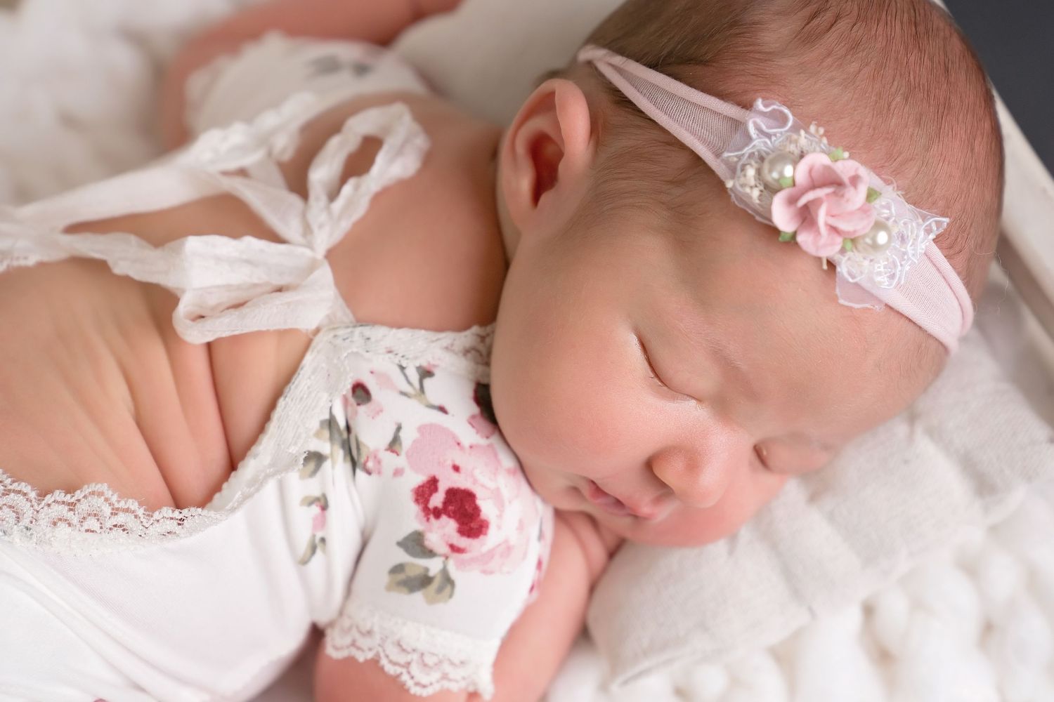 Sweet newborn portrait session with lace headband and soft white wrapping. San Diego Newborn Photographer