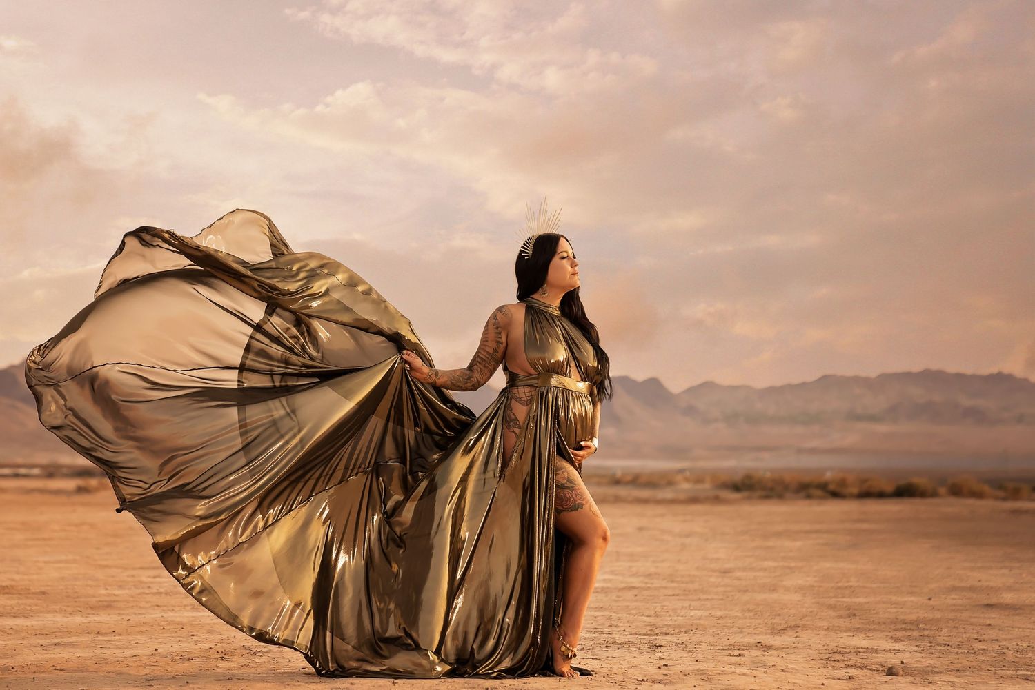 las vegas maternity session Flowing fabric catches wind against desert mountain landscape.