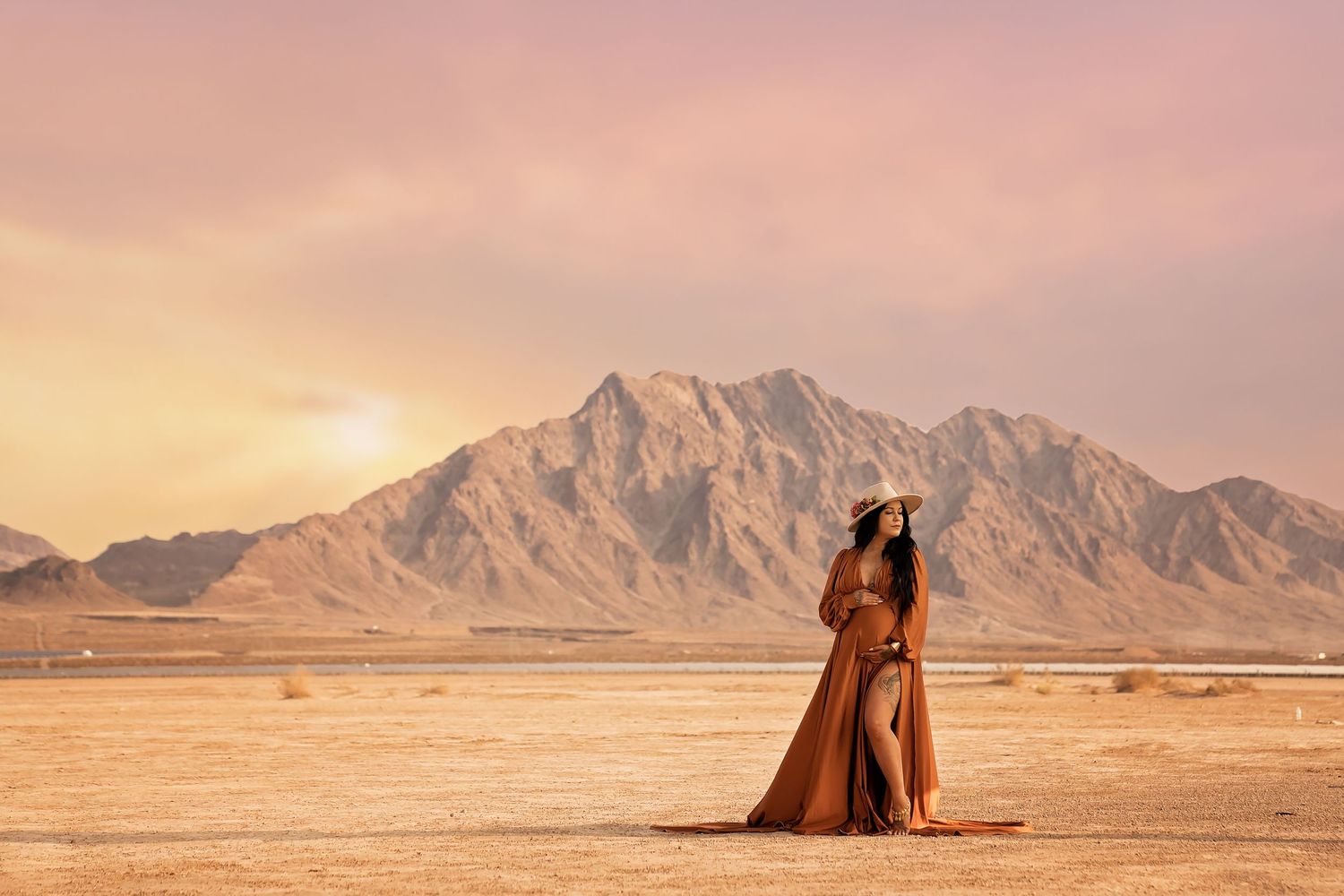 Las vegas maternity session. Dramatic desert landscape with mountains and warm sunset lighting.
