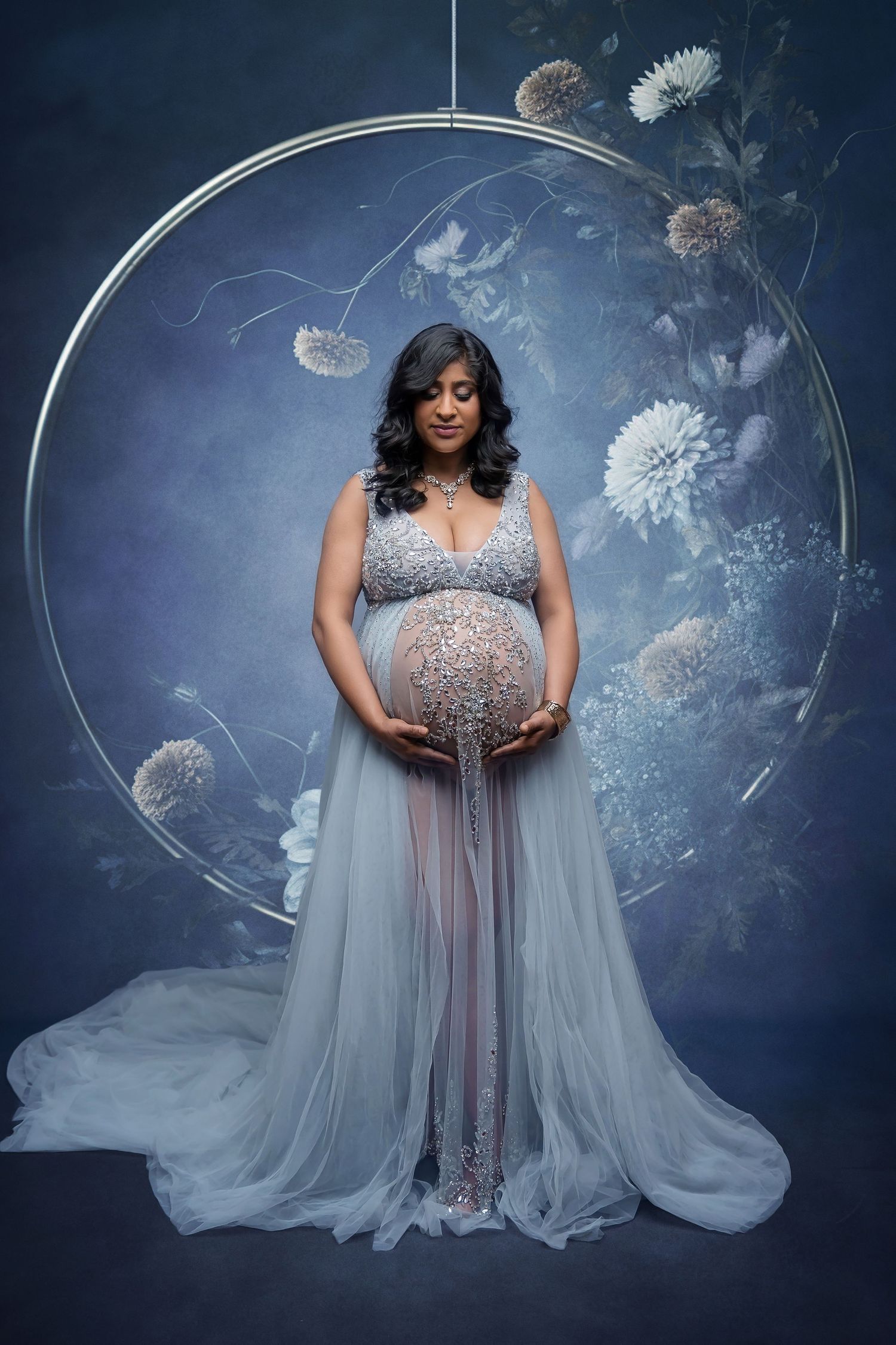 Ethereal maternity portrait with silver gown and dreamy dandelion backdrop