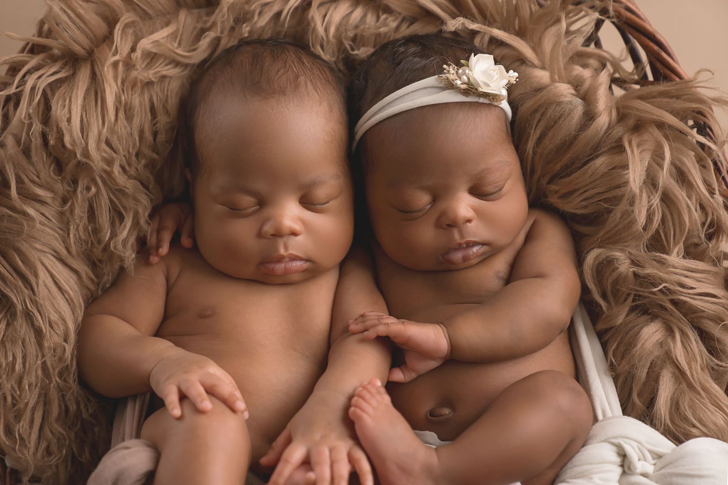 Twin babies sleeping peacefully on brown textured blanket. San Diego Newborn Photographer