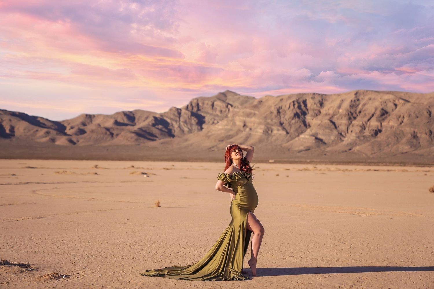 maternity photo in Desert landscape photoshoot with dramatic mountain backdrop at sunset. San Diego Maternity Photographer