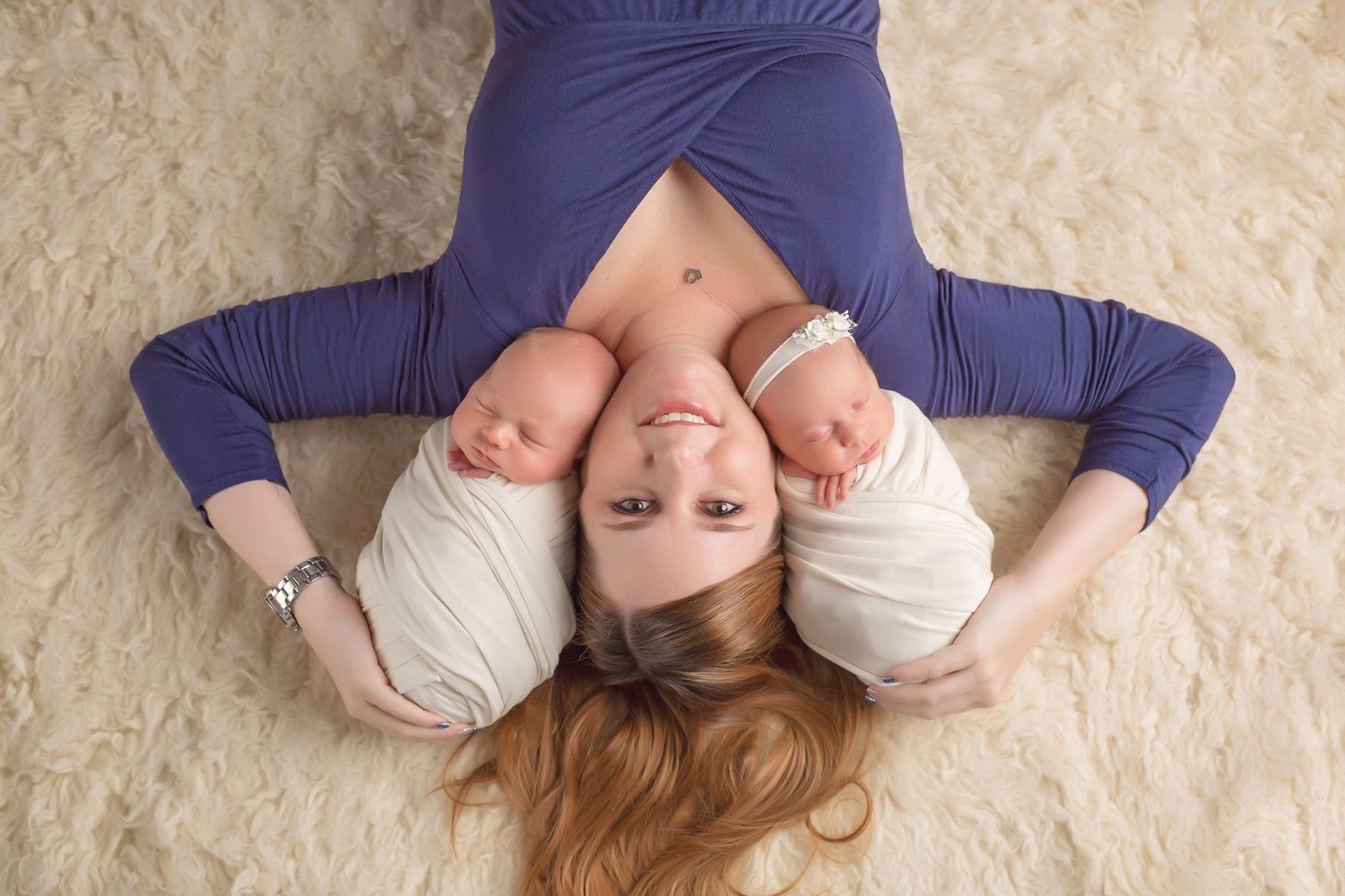 Studio portrait series on cream colored carpet with navy blue clothing. San Diego Newborn Photographer