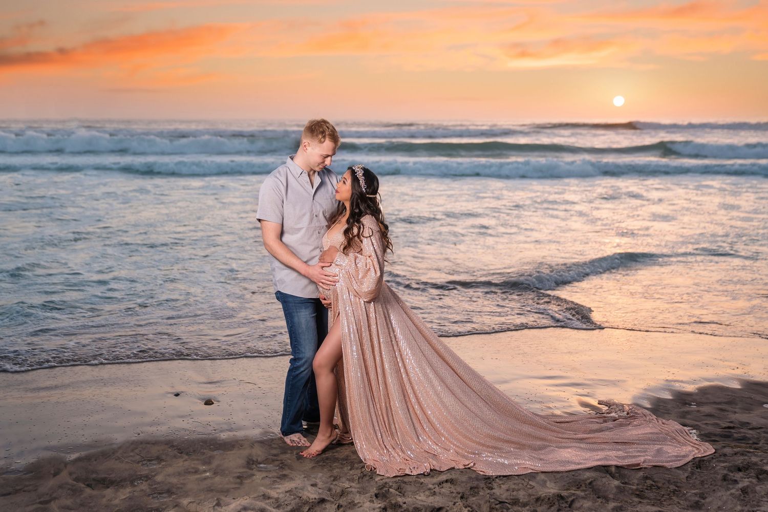 Romantic maternity beach portraits with flowing blush gown during golden hour sunset. San Diego Maternity Photographer