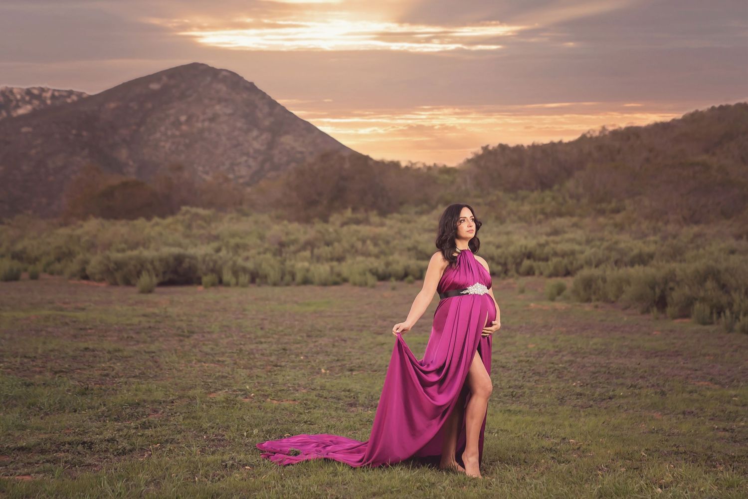 Sunset maternity session with magenta dress against mountain backdrop. San Diego Maternity Photographer