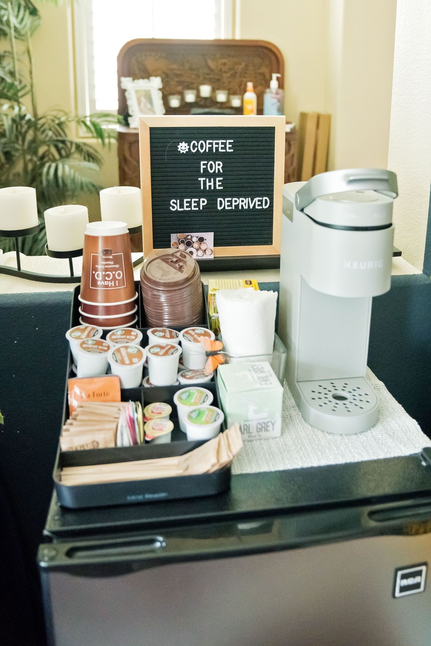 Multiple shots of a minimalist coffee station setup with letter boards, white ceramic mugs, and wooden serving trays.