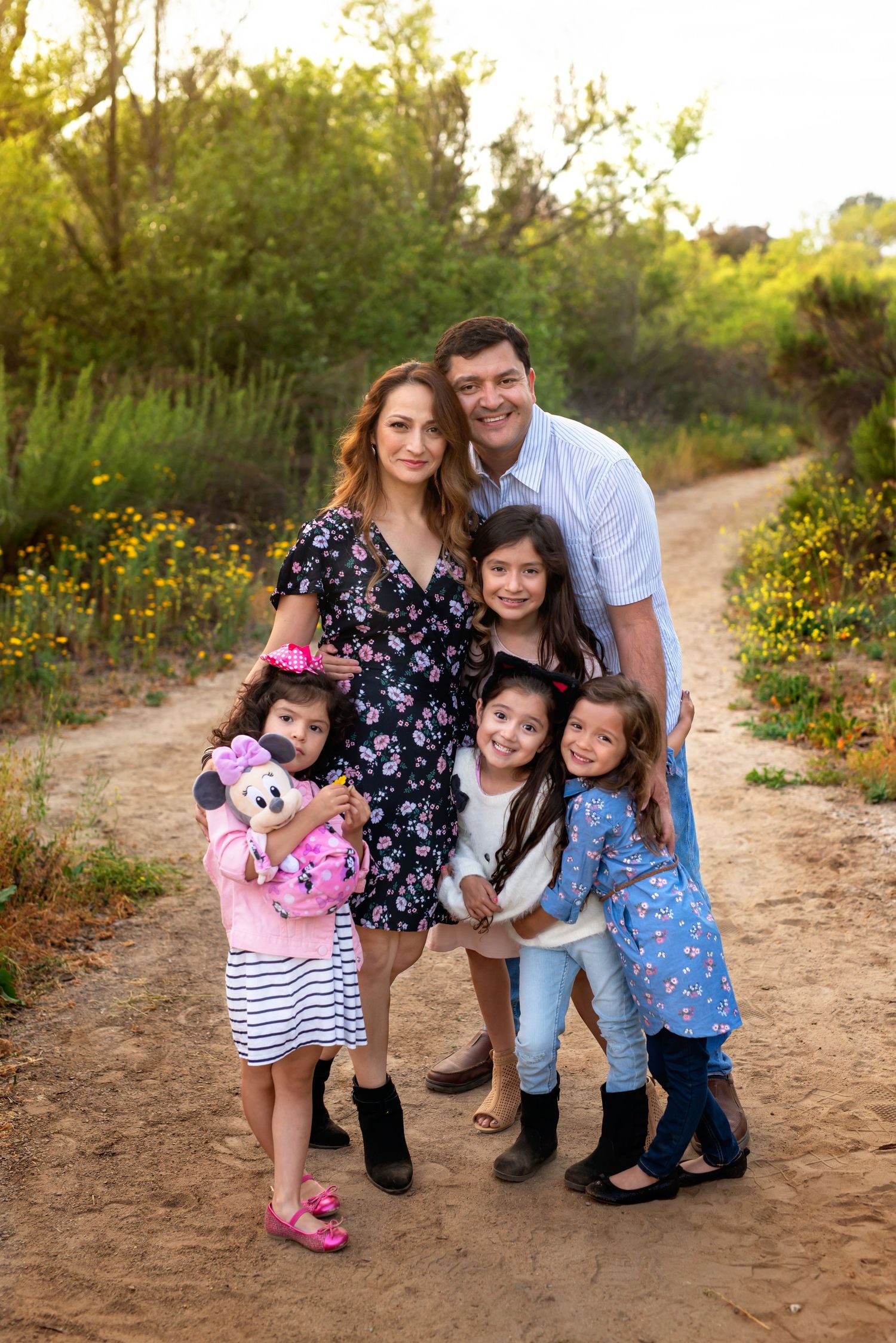 Casual san diego family photos on a dirt path surrounded by spring wildflowers.