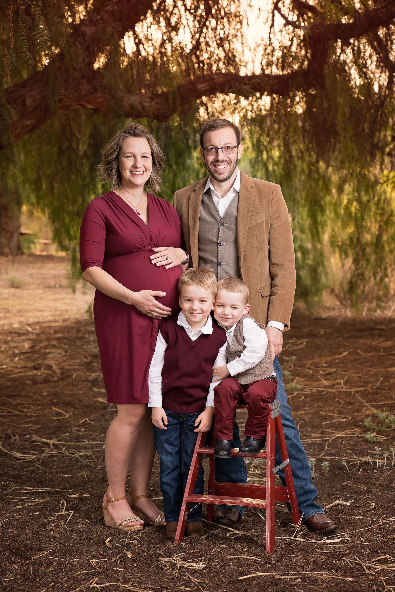 outdoor family session with fall colors and a red ladder