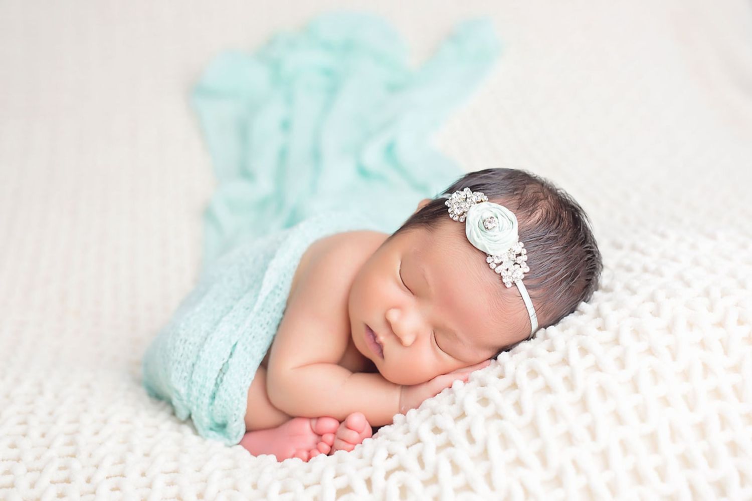 Newborn photography series with mint green blanket and white polka dot accessories. San Diego Newborn Photographer