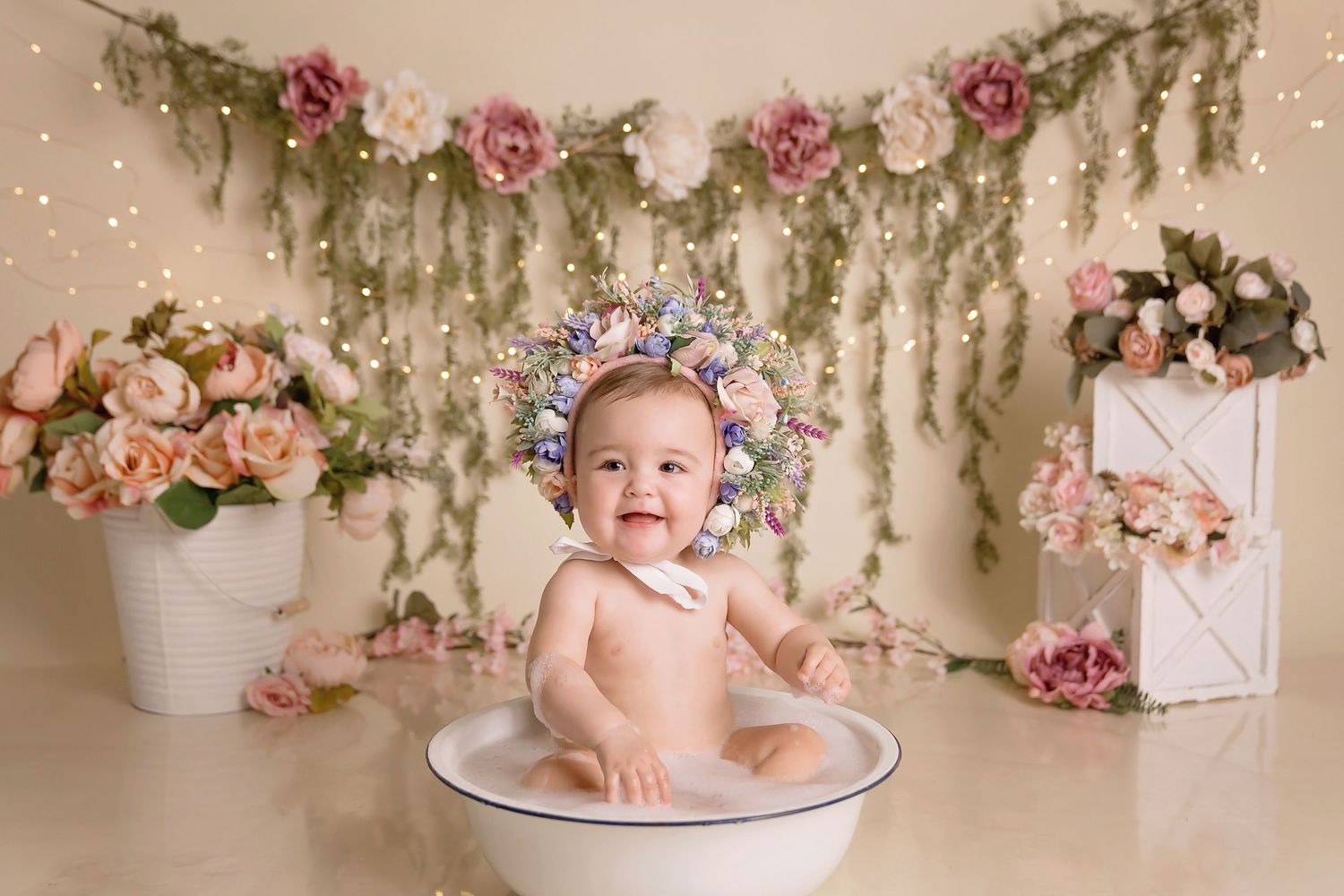 San Diego Cake Smash photo with Romantic garden-themed photo setup with hanging florals and soft lighting. San Diego cake smash photographer