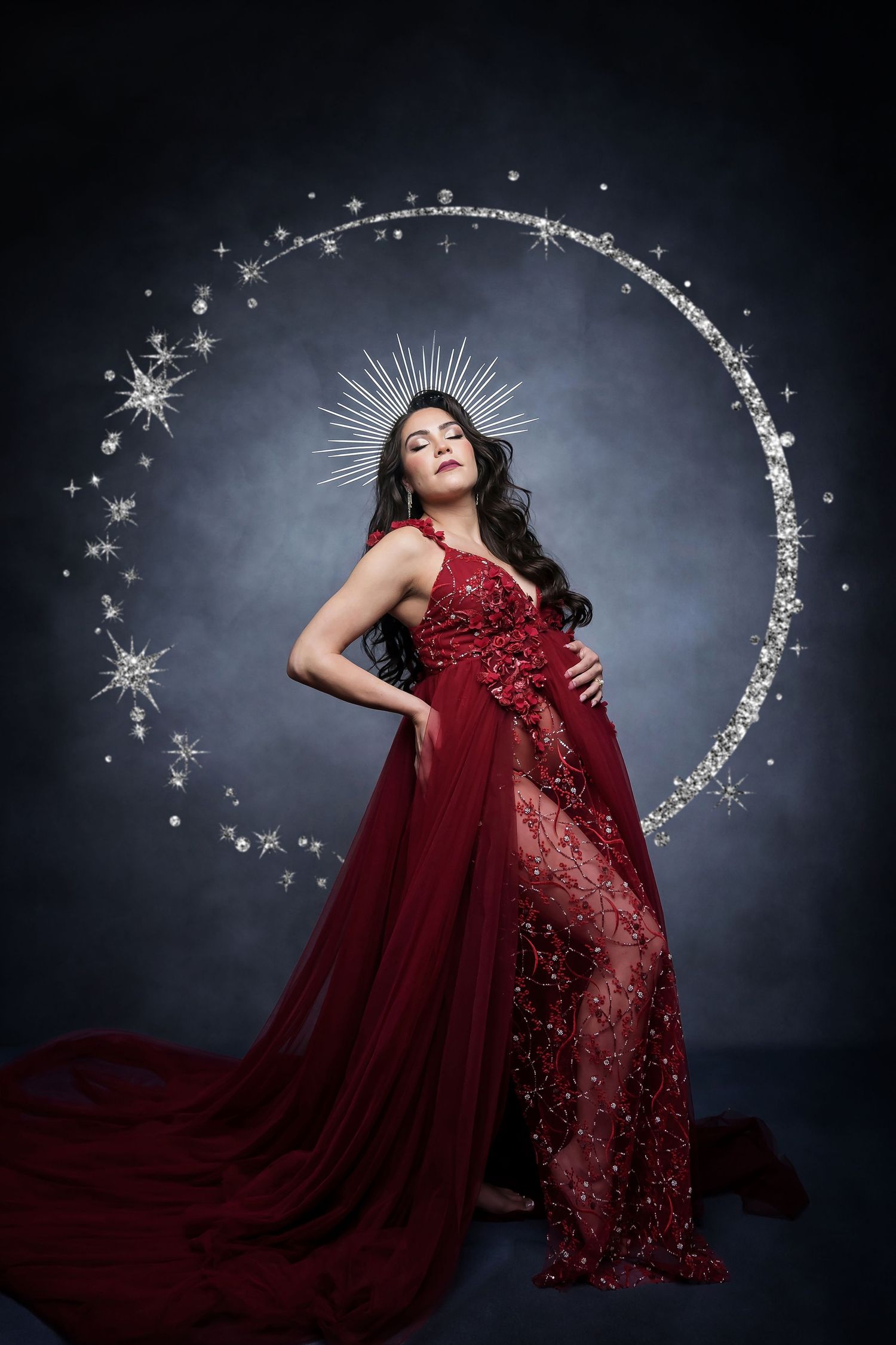 Celestial-inspired maternity portrait with sparkly red gown and star lighting