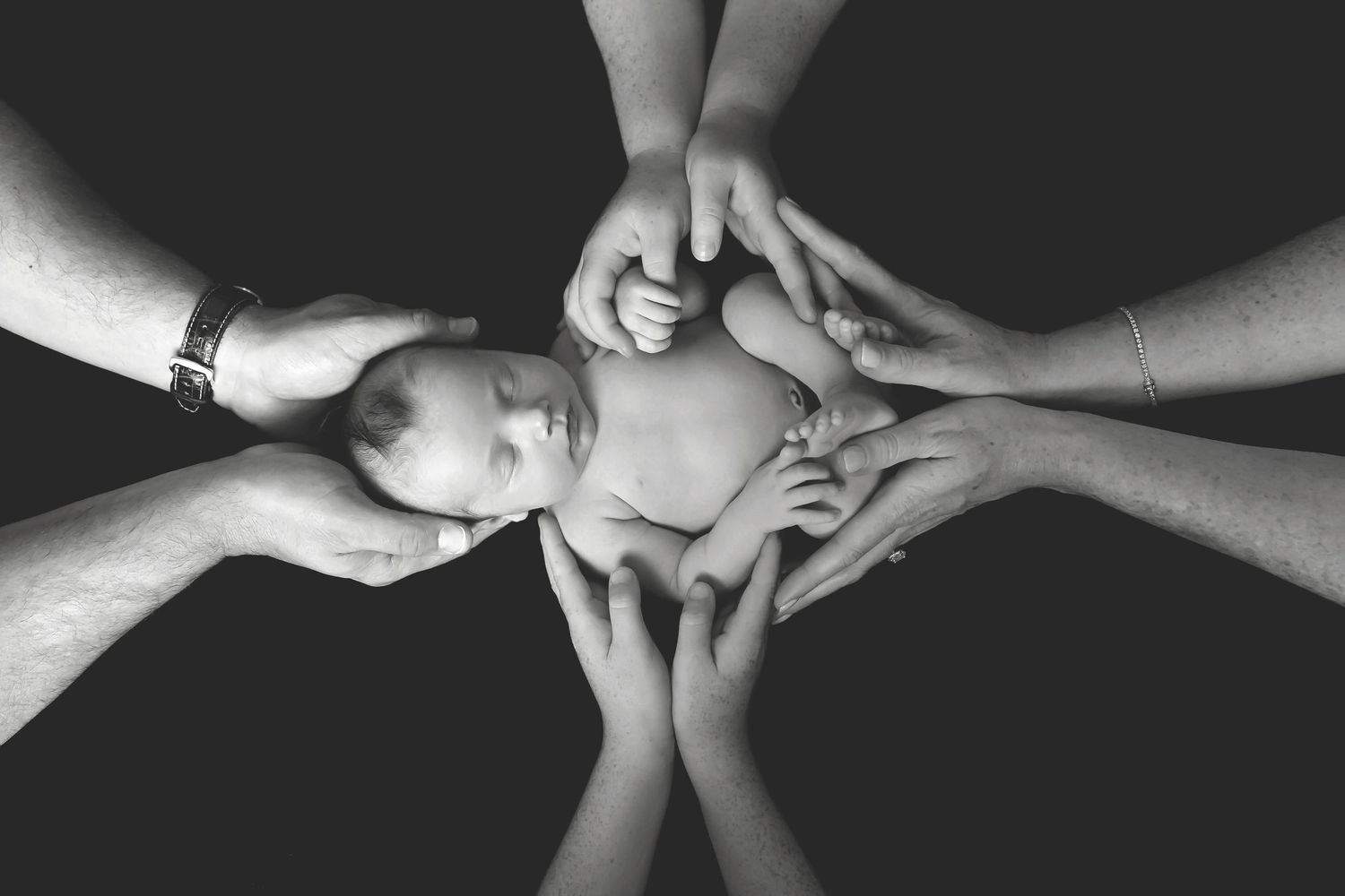 Black and white image series showing gentle hands supporting baby. San Diego Newborn Photographer