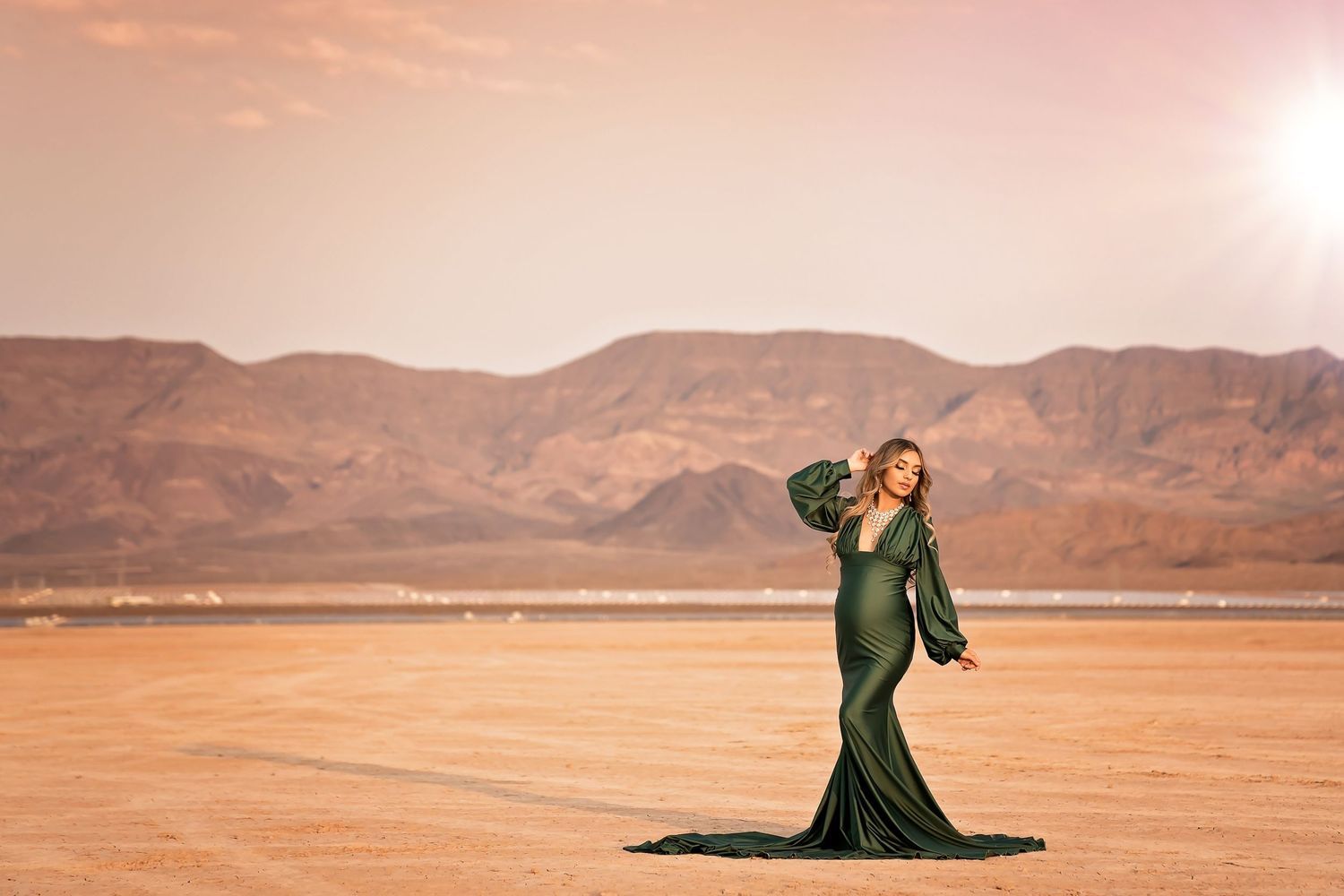 Dramatic desert photoshoot with mountains and sunset sky. San Diego Maternity Photographer