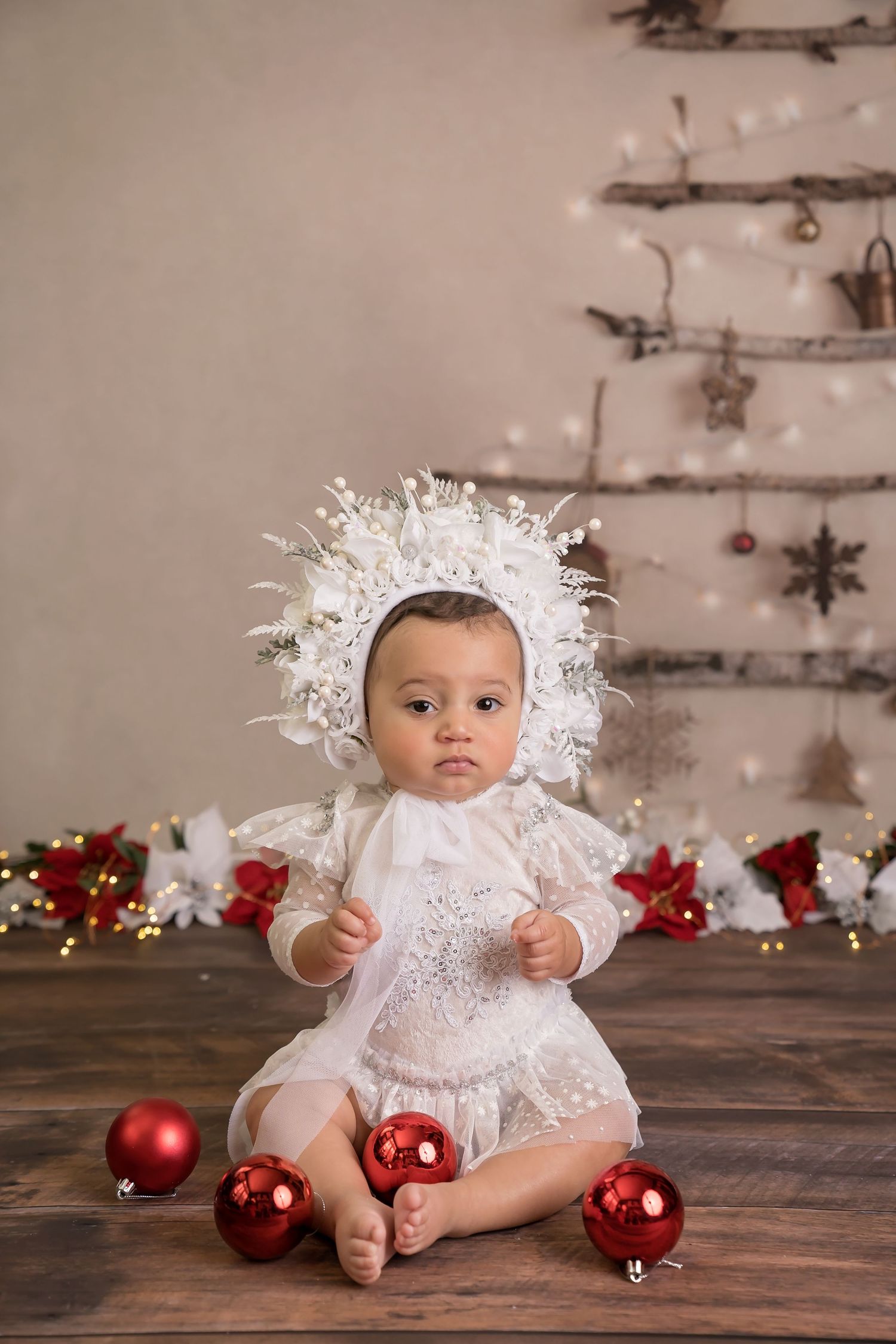 Christmas themed photo setup with red ornaments and rustic wooden backdrop. San Diego cake smash photographer