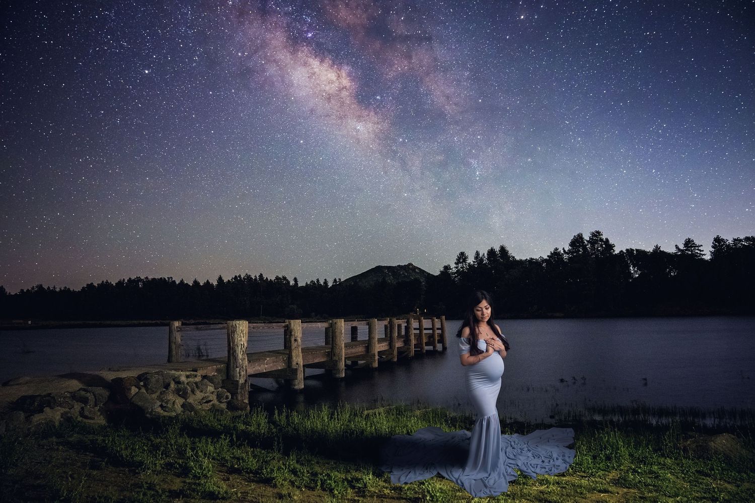 Milky way Maternity photo session in San Diego. Silhouette maternity portrait against starry night sky and lake backdrop.