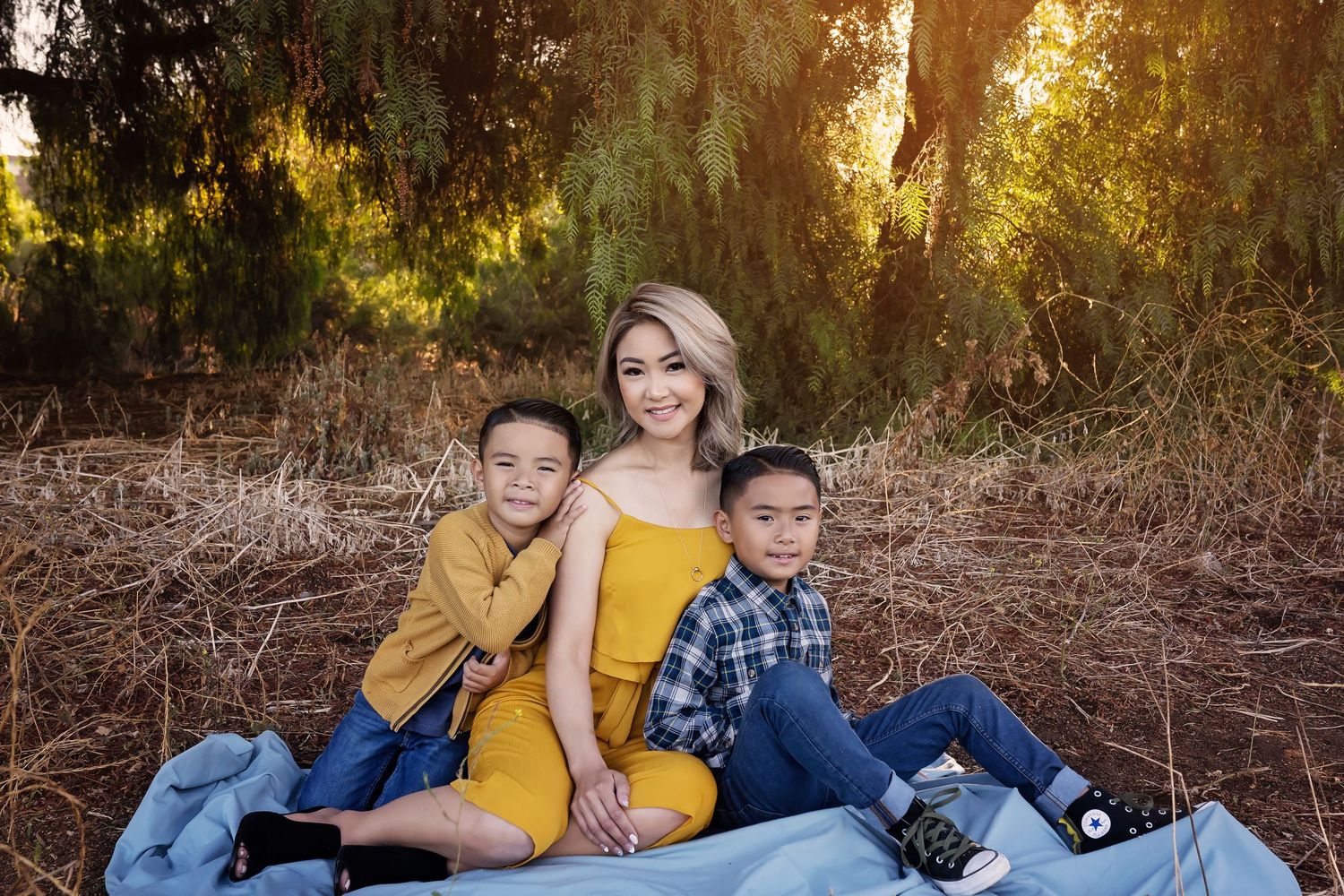 Family lounging together on a blanket during golden hour in a relaxed outdoor session