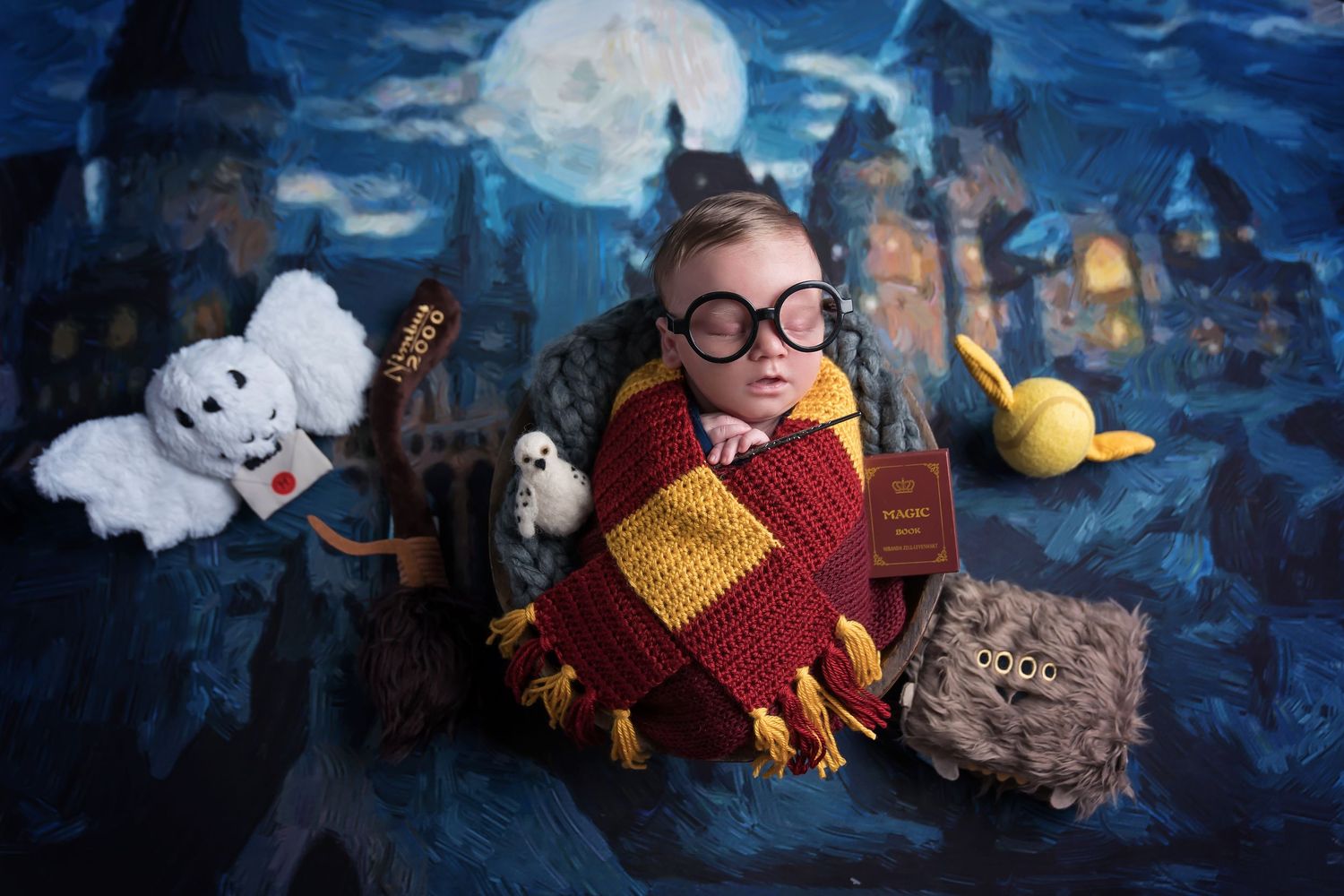 Baby dressed in Harry Potter themed costume with magical props and moonlit castle background. San Diego Newborn Photographer