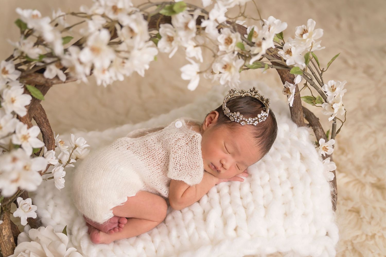 San Diego newborn photographer captures newborn photography photos with white floral decorations and lace in neutral cream tones.